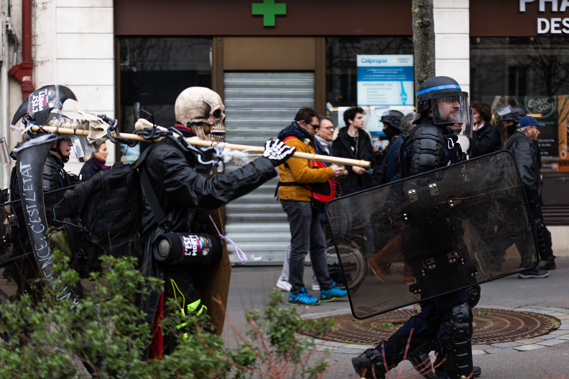 A man dressed as a skeleton seen behind a policeman during the demonstration. Thousands of French people gather and march on the streets of Paris on March 15, which marks the eighth general strike against the new Macron's pension reform.