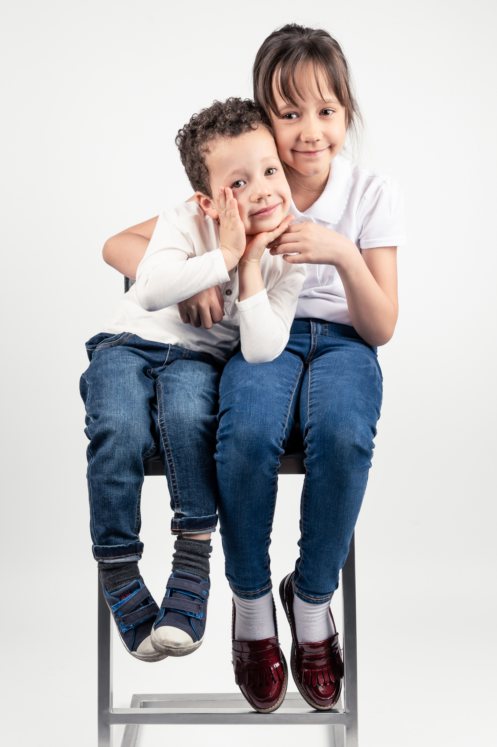 Brother and sister photoshoot in Bolton, Manchester, studio, white background, chair