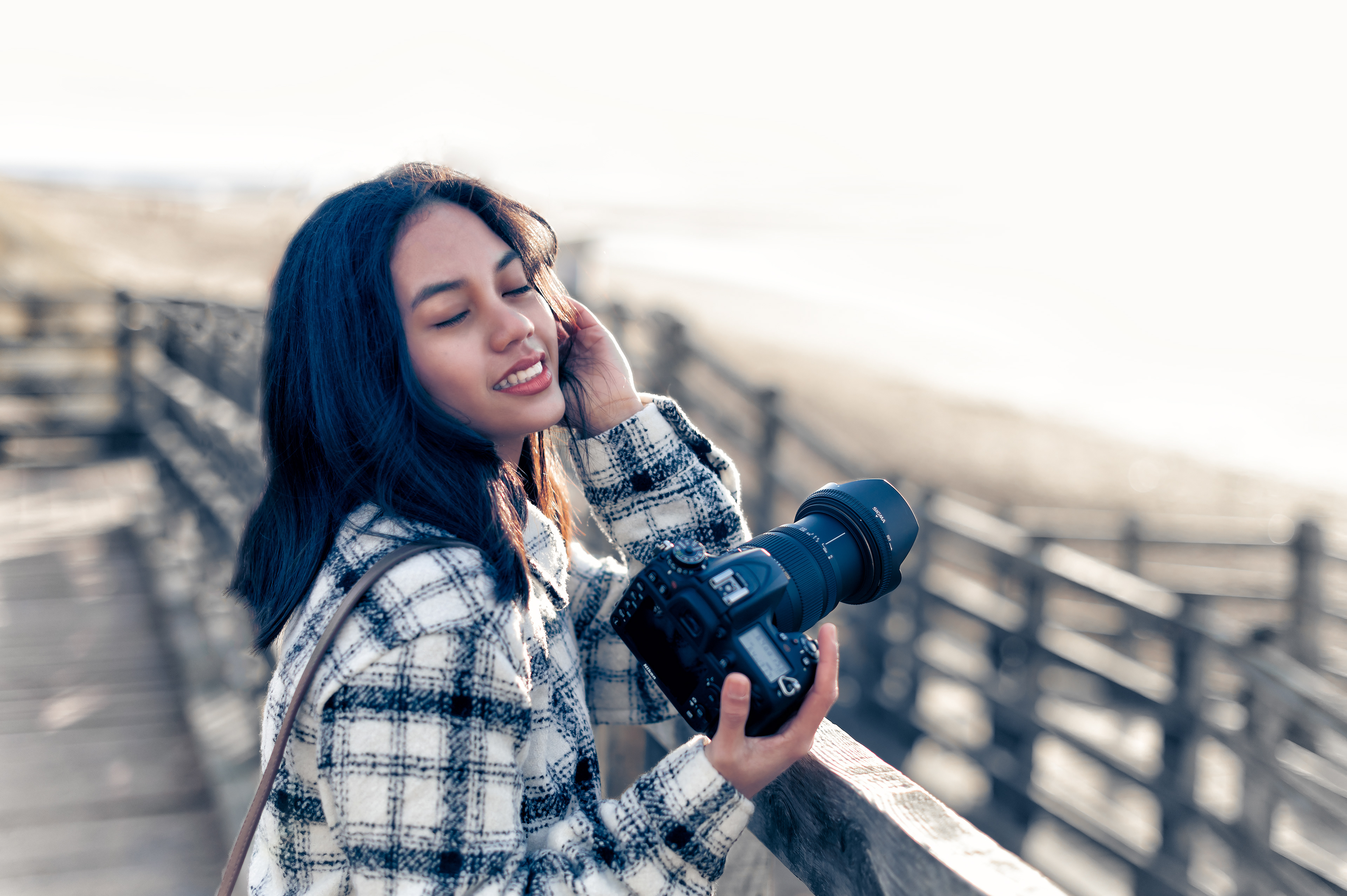 Photographer Girl shooting Nikon outdoors, at Formby beach Liverpool