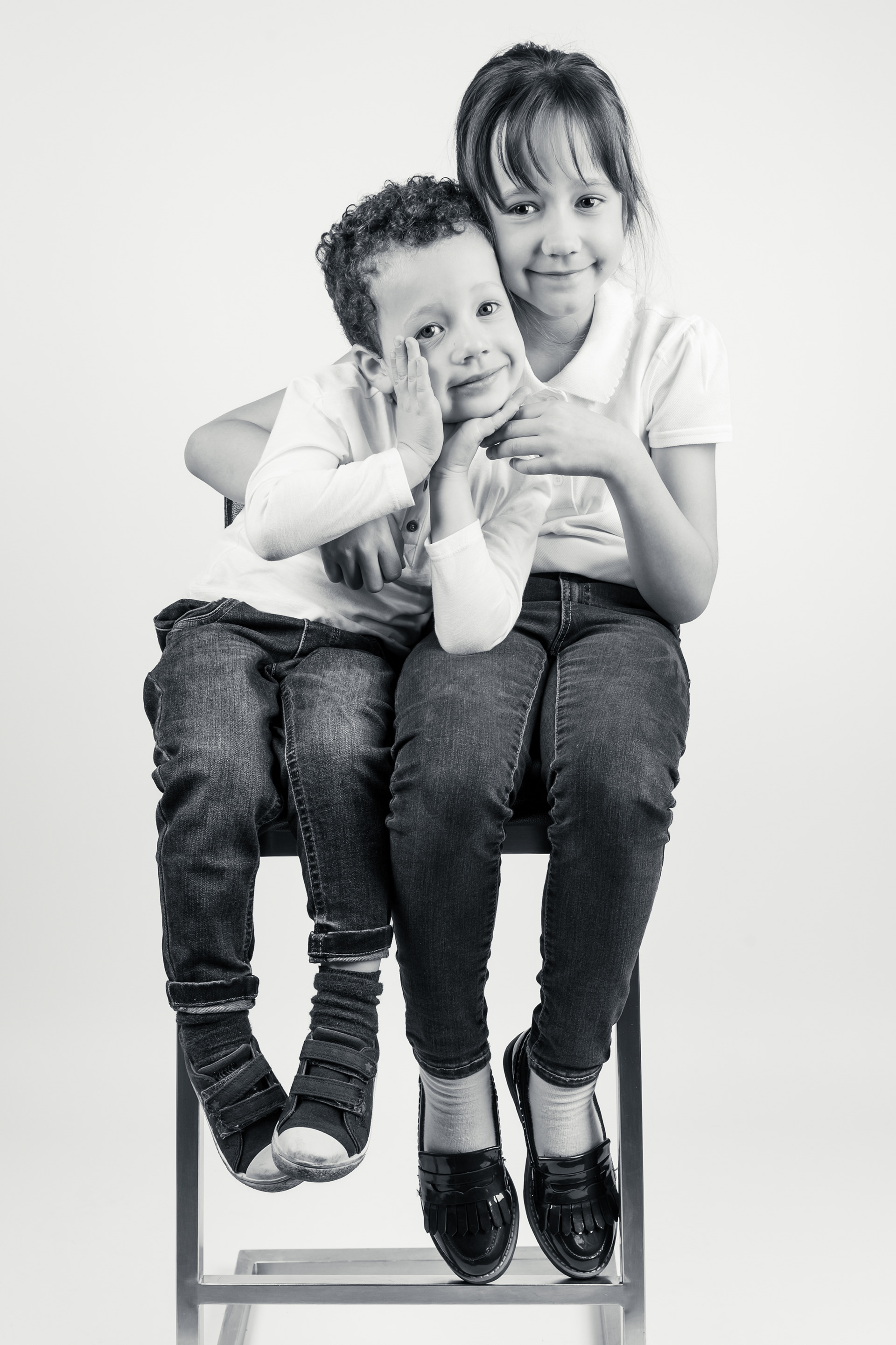 Brother and sister photoshoot in Bolton, Manchester, studio, white background, chair