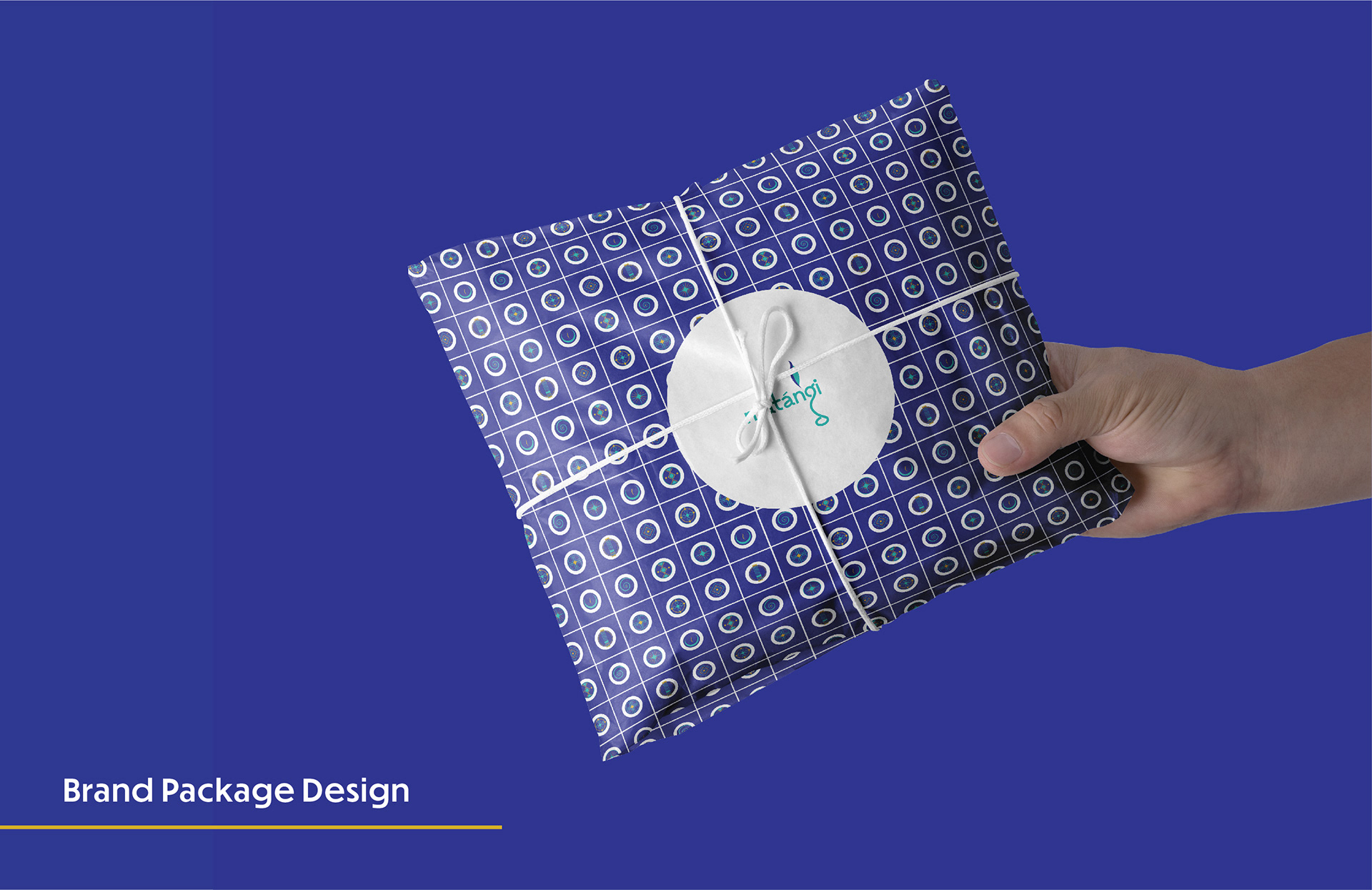 Matangi spiritual brand: package design with patterned wrapping paper held in hand