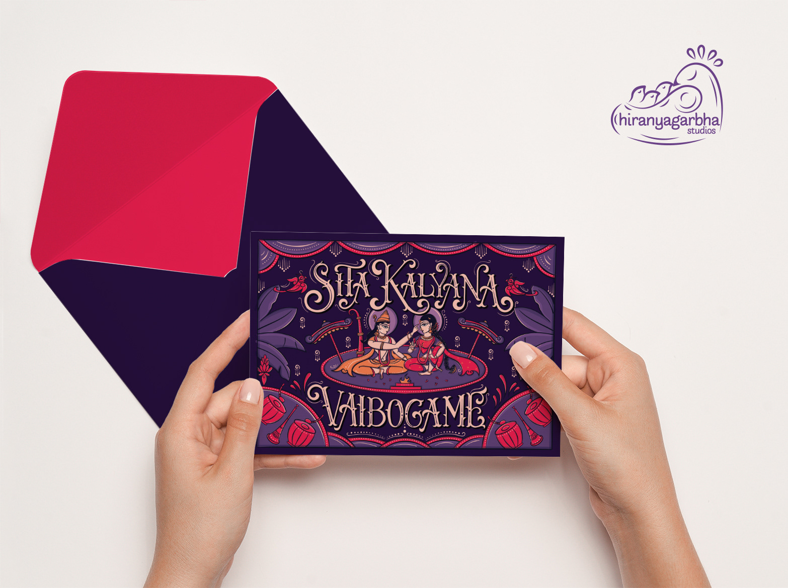 Sita Kalyana Vaibogame Brahmin wedding invitation: hands holding the invitation front with a red envelope