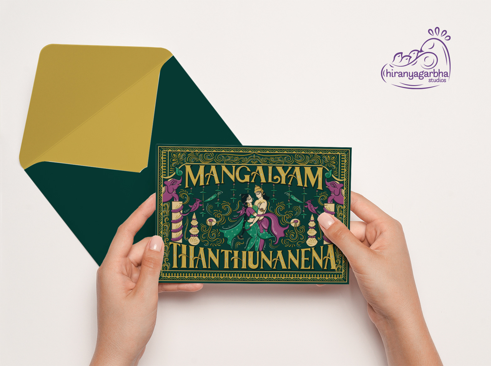 Mangalyam Thanthunanena Brahmin wedding invitation: hands holding the invitation front with a gold envelope
