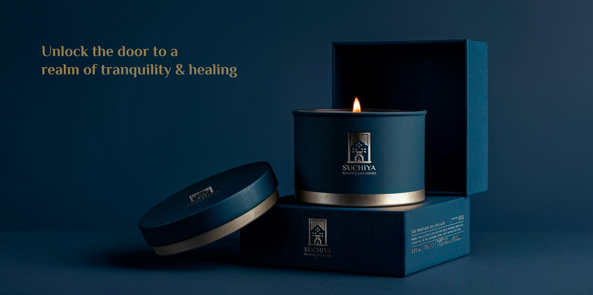 Suchiya home fragrances brand: scented candle in a tin with dark gift boxes