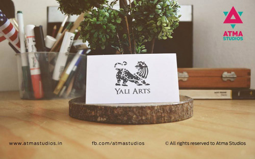 Logo designs 2015 by Atma Studios: Yali Arts logo on a card on a desk