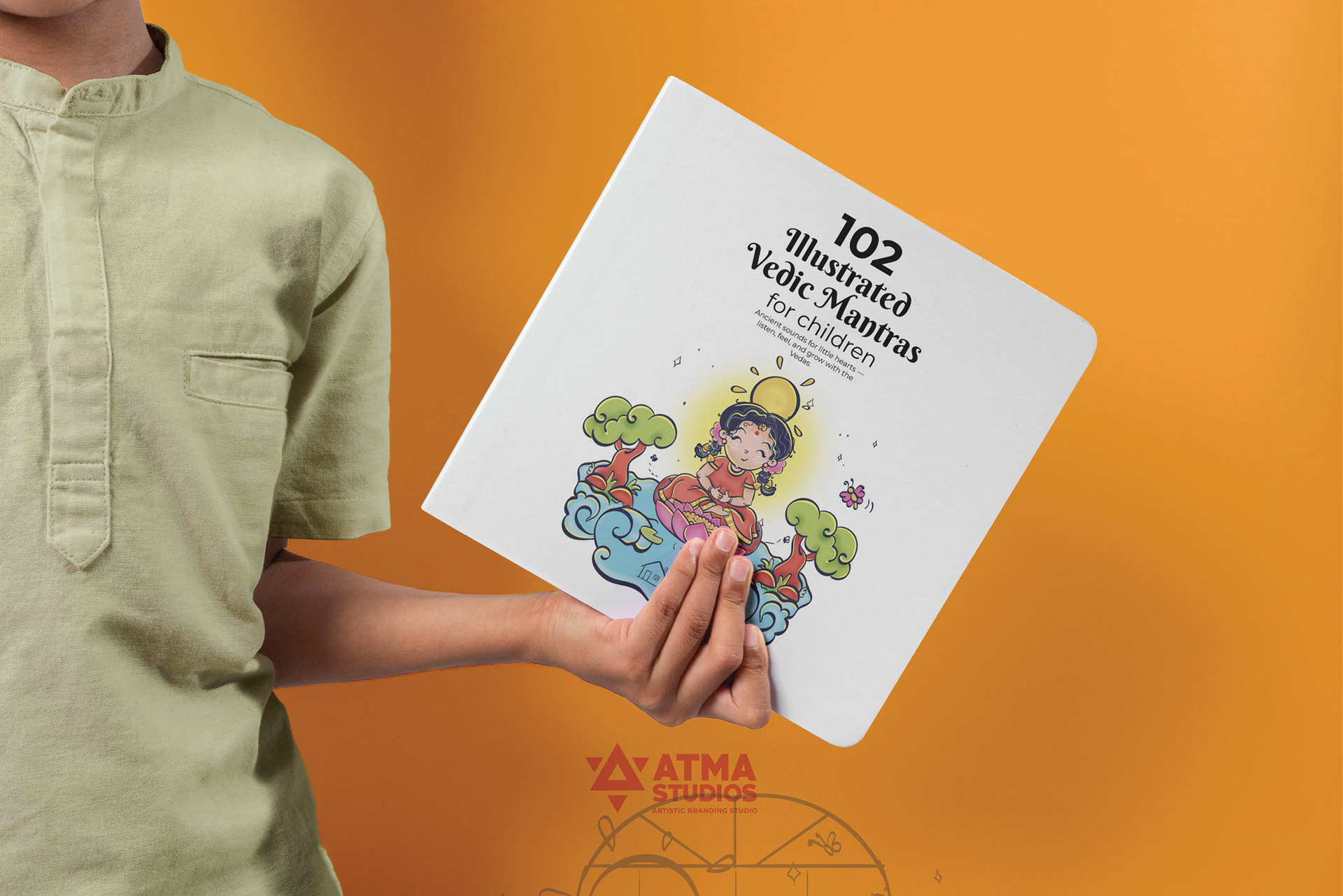 Illustrated Vedic mantras for children book: child holding the book, 102 illustrated Vedic mantras
