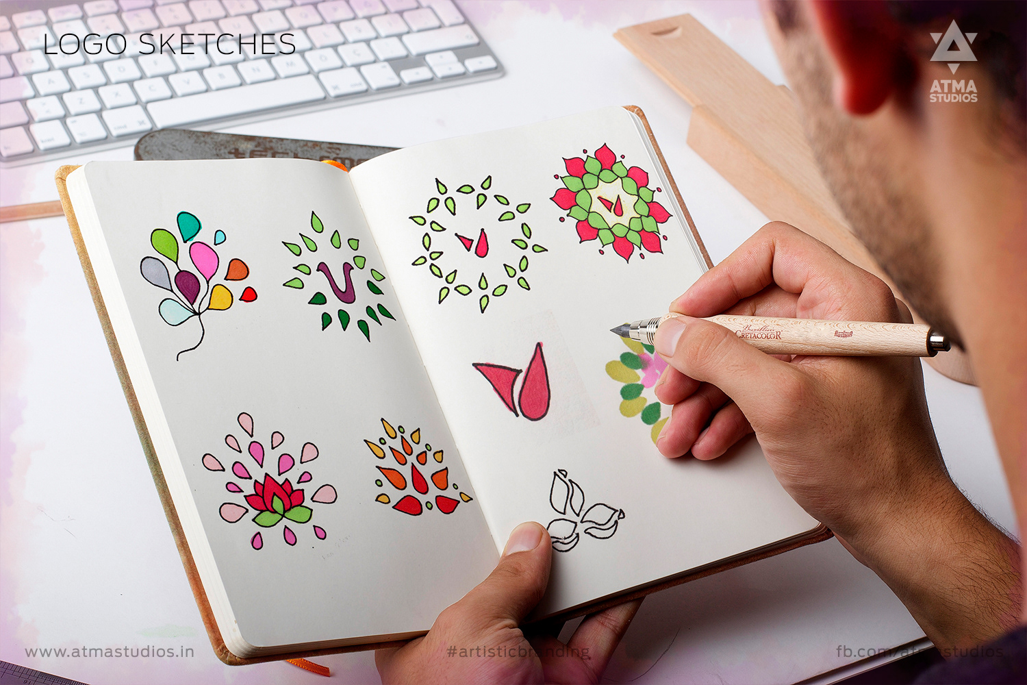 Vilvaa online garland store brand: hand sketching lotus logo ideas in a notebook