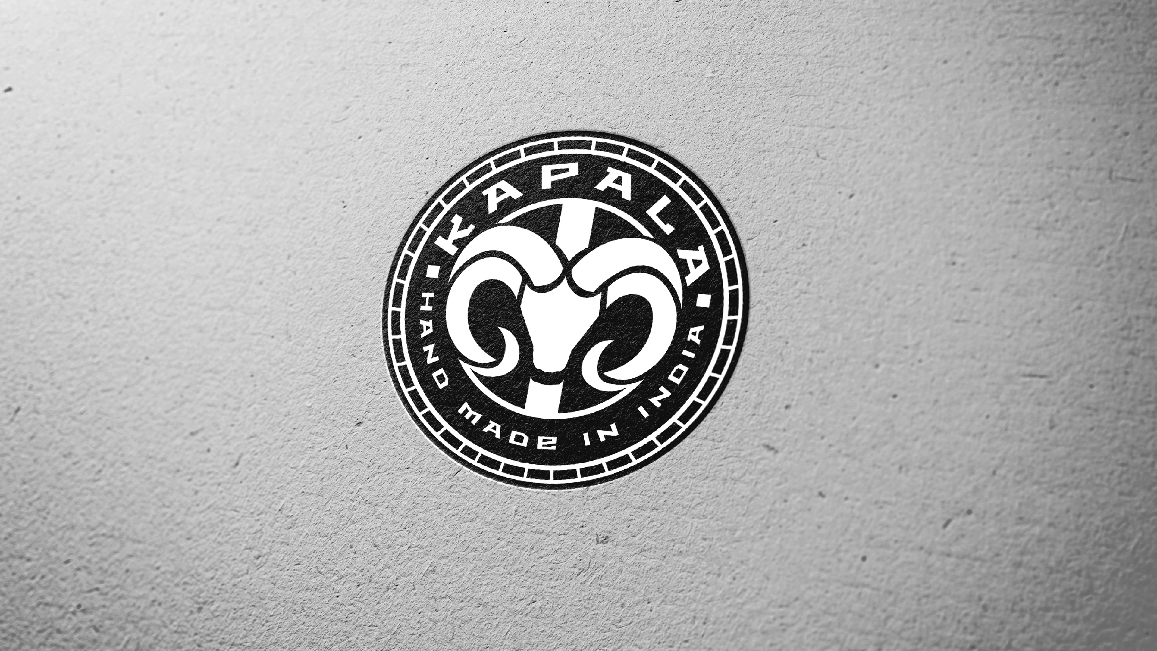 Kapala cycling brand identity: ram badge logo printed on textured paper