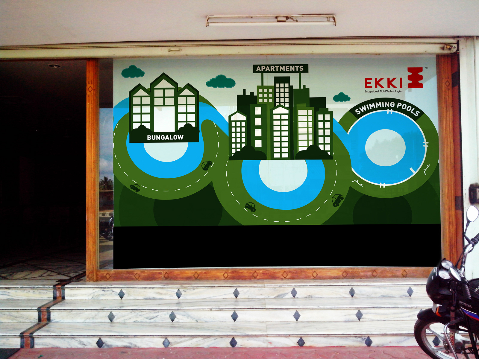 Ekki Pumps exterior wall illustration: installed green cityscape panel at the entrance
