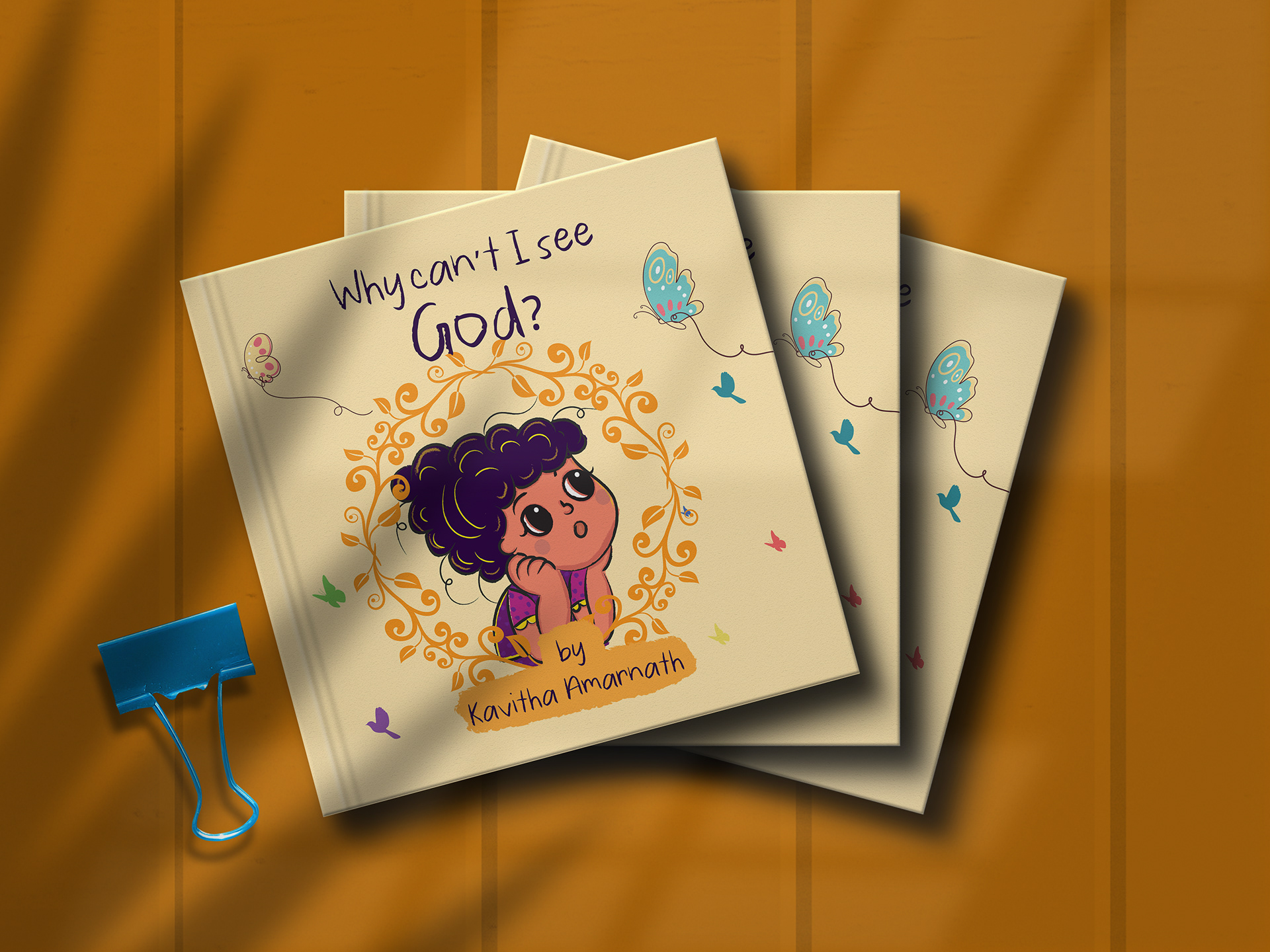 Why Can't I See God? children's book by Kavitha Amarnath: printed books on a wooden table