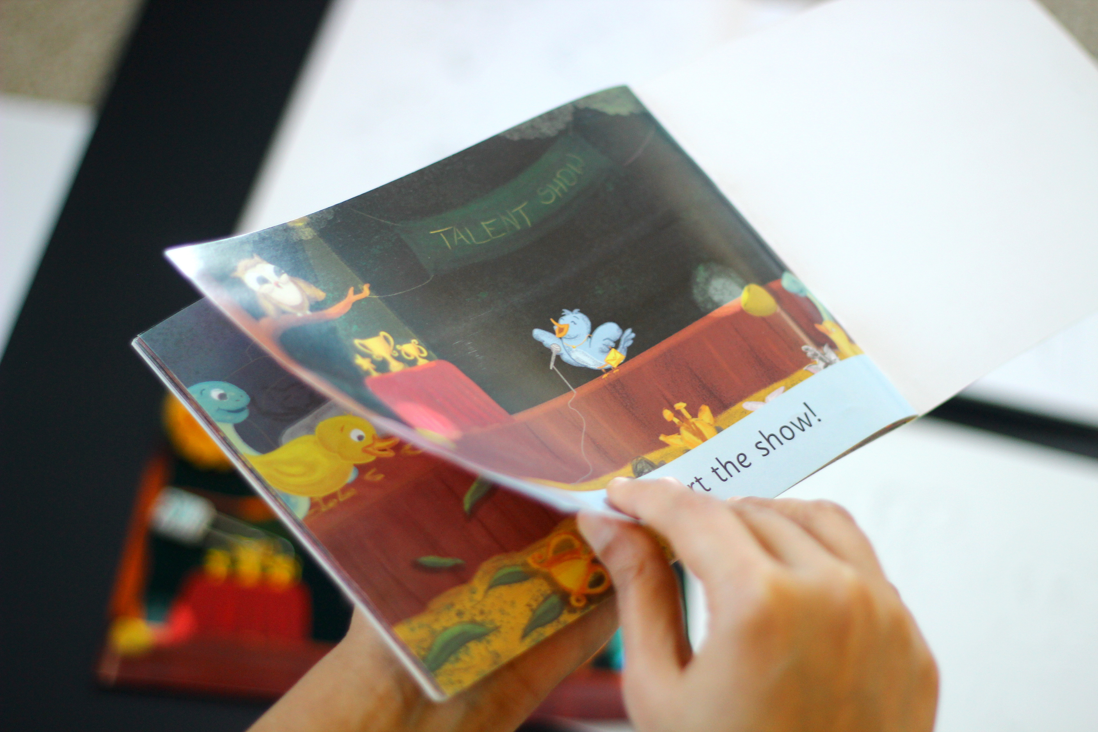 The Missing Prizes children's book: hands turning the pages