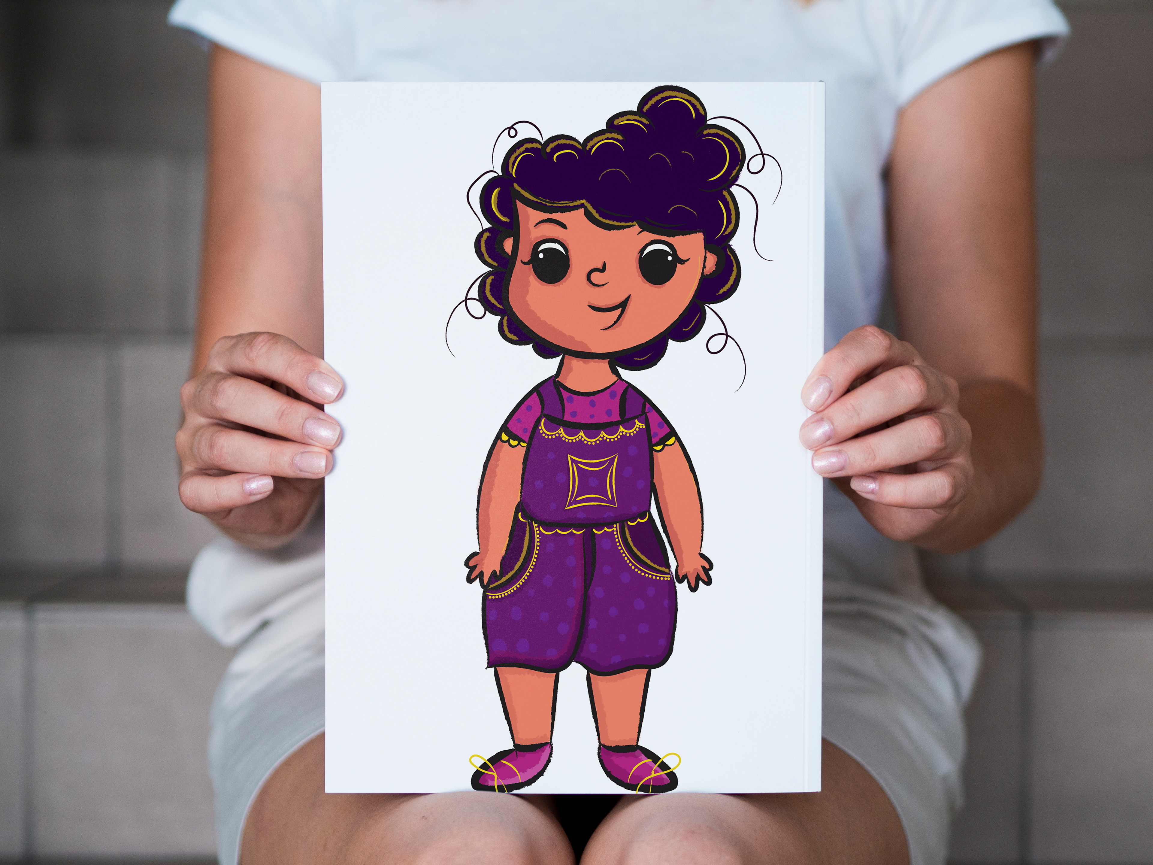 Why Can't I See God? children's book by Kavitha Amarnath: hands holding a print of Komal