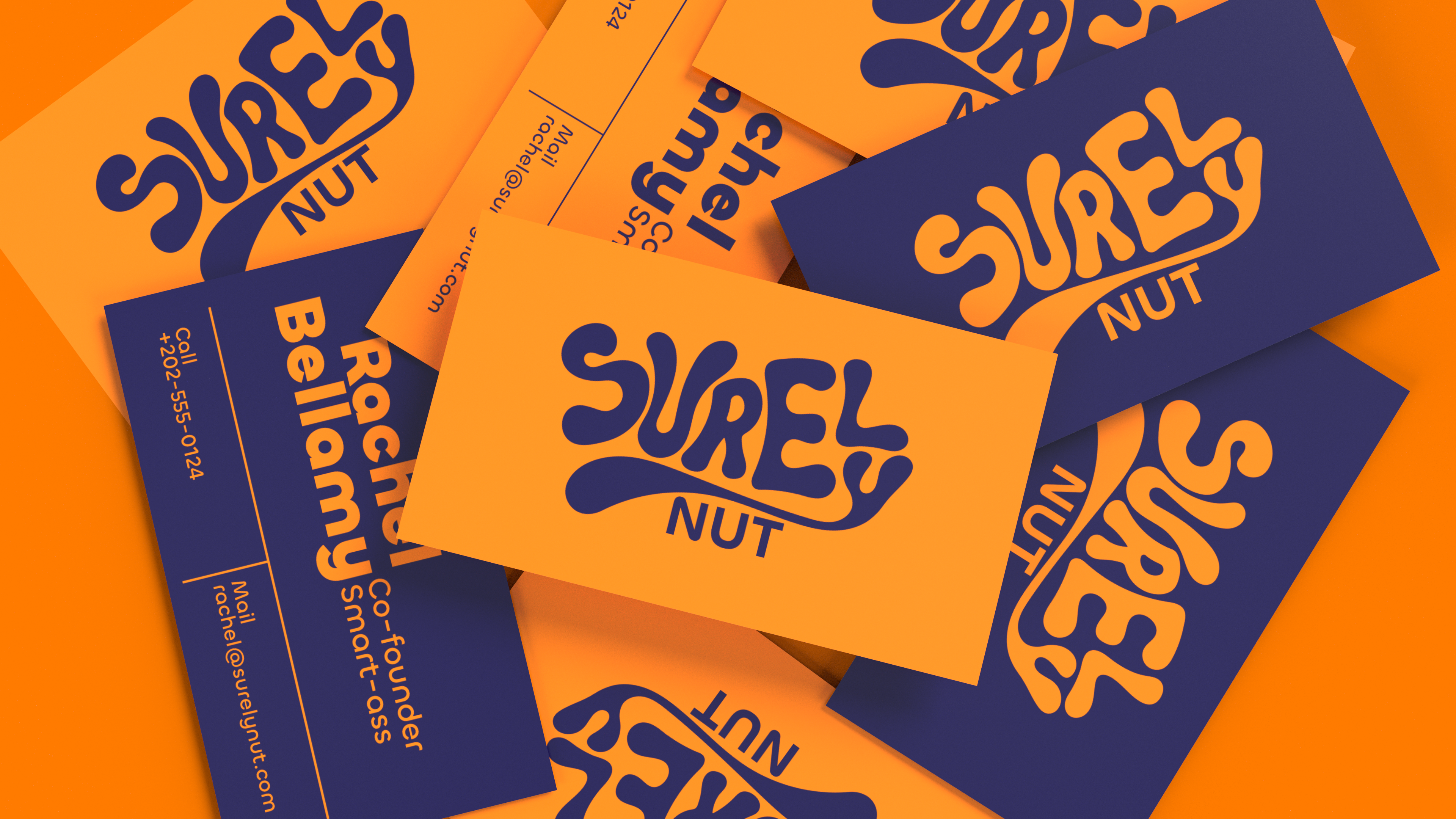 Surely Nut nut butter branding and packaging: scattered business cards in orange and navy