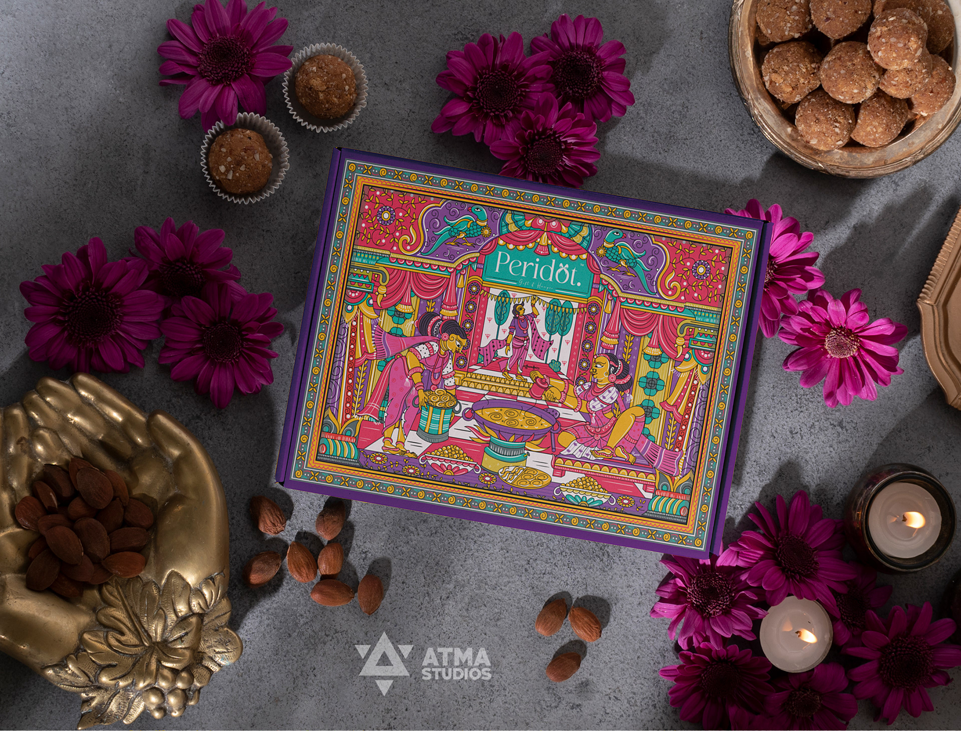 Peridot Diwali sweet box package design: sweet box on a table with marigolds and diyas