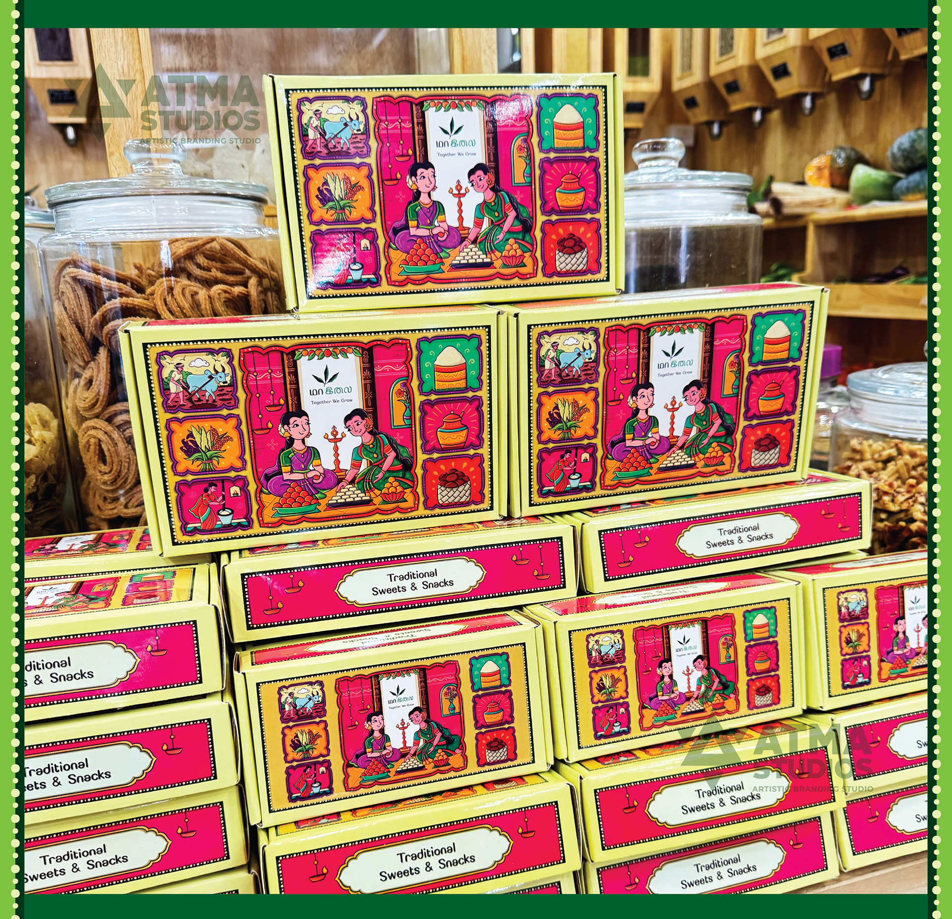 Maa Ilay illustrated sweet box package design: stacked sweet boxes on a store display