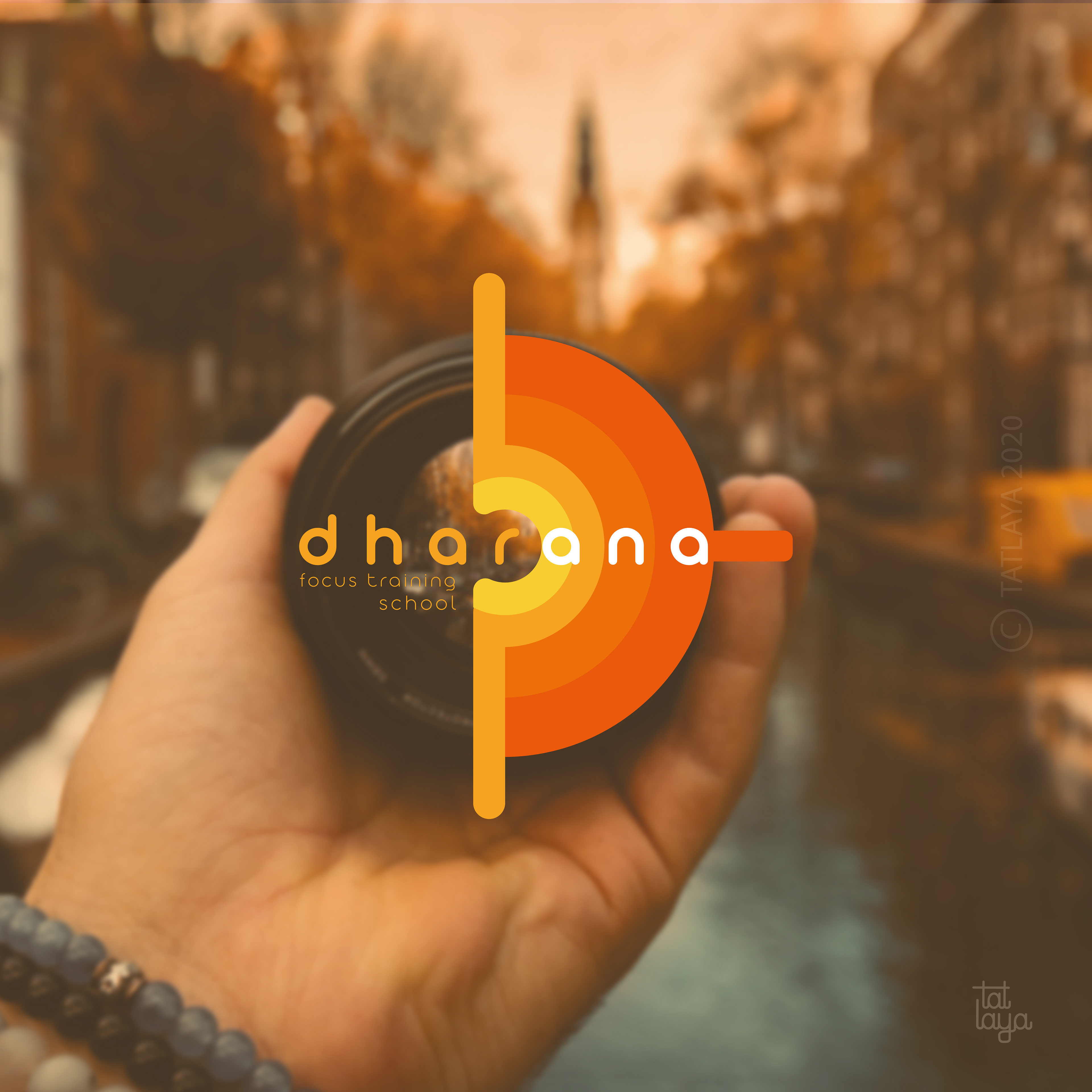 Top logo designs 2020 by Atma Studios: Dharana logo on a camera lens held over an autumn street