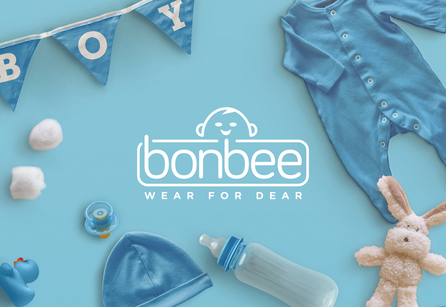 Bonbee Indian baby wear brand and package design: white logo on a blue flat lay of baby boy clothes and bottle