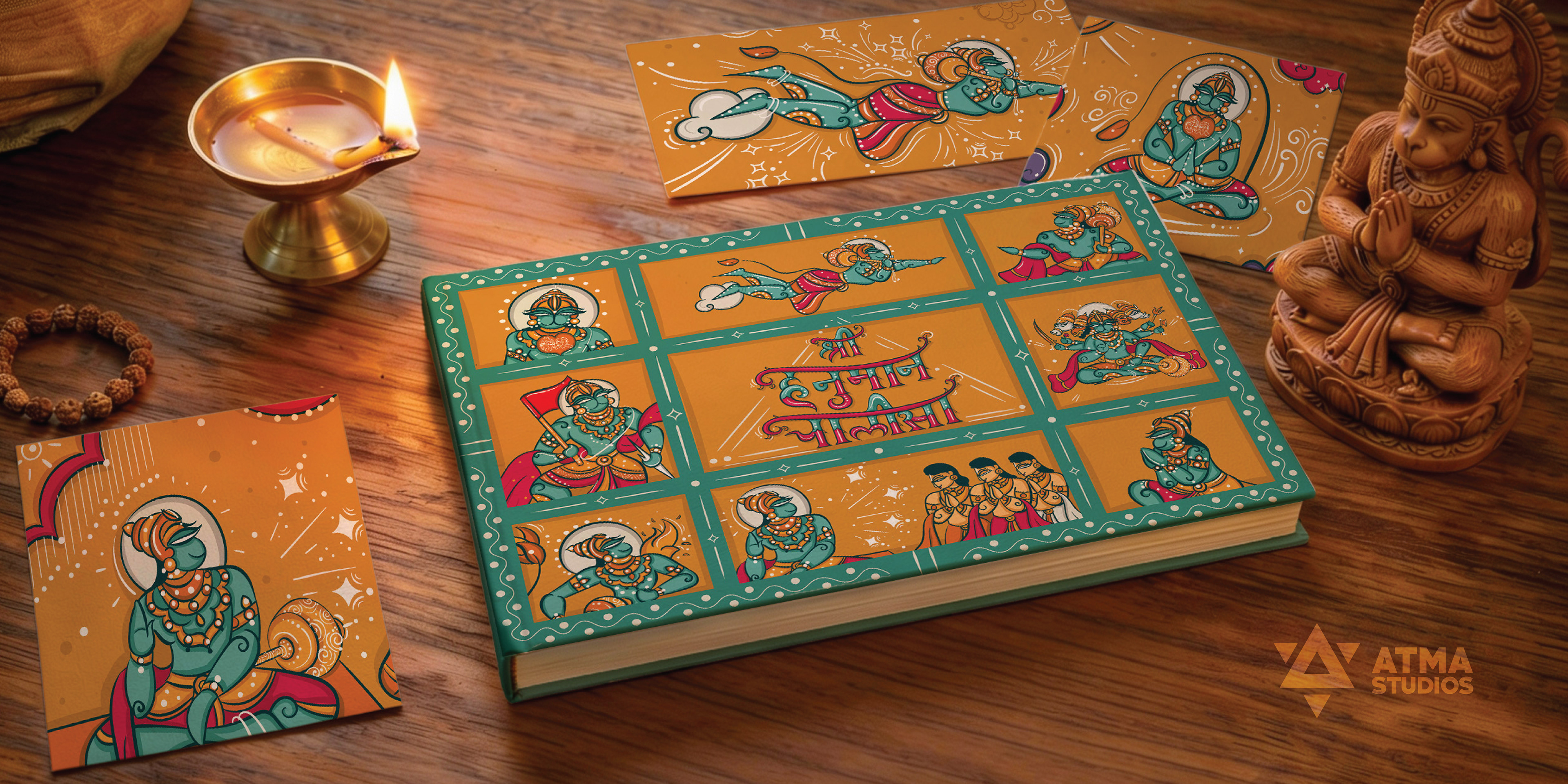 Hanuman Chalisa children's book: illustrated book with a grid of Hanuman scenes beside a brass lamp, book design and illustration by Atma Studios