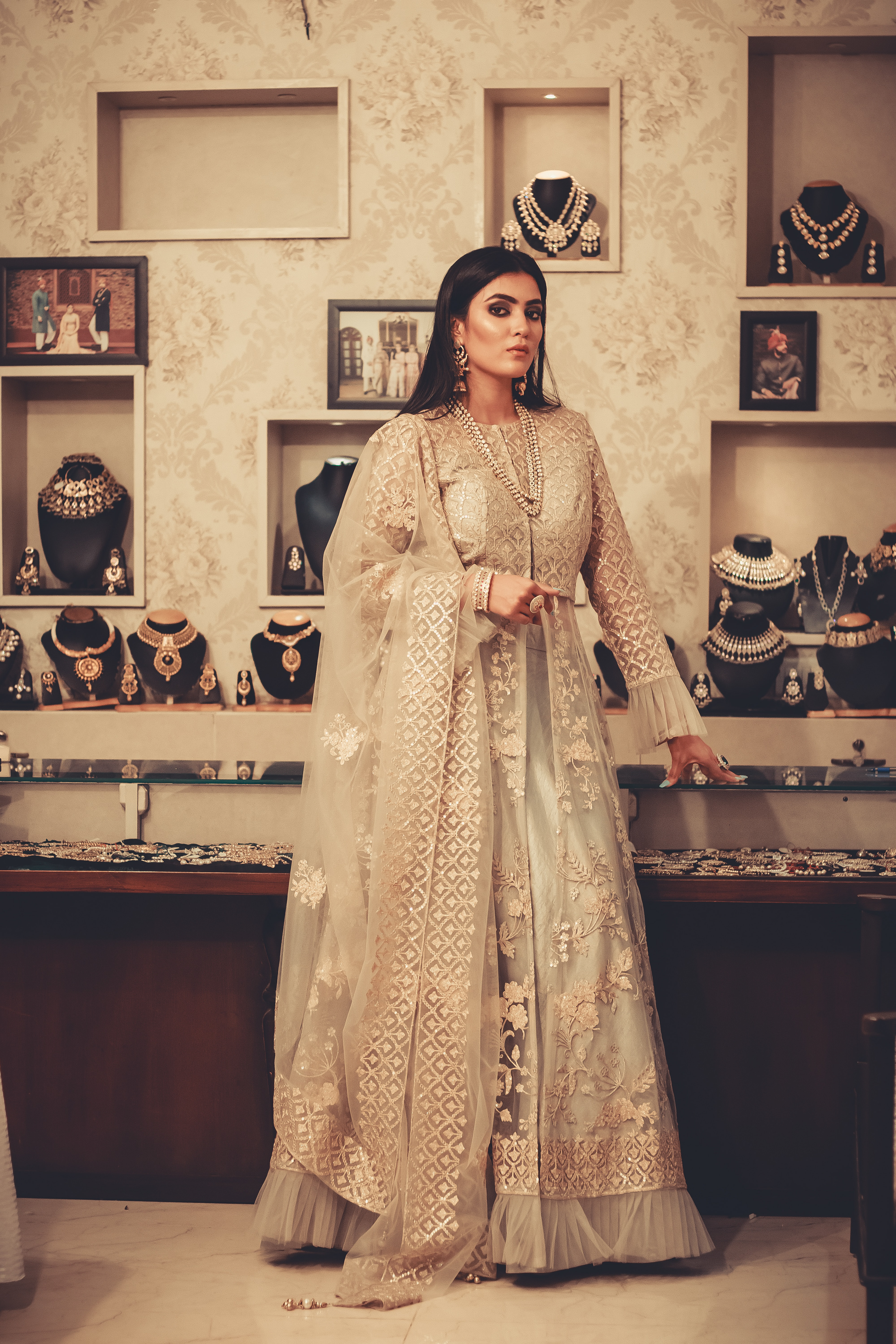 Sogant Studio couture branding: model in an embroidered gown in a jewellery boutique