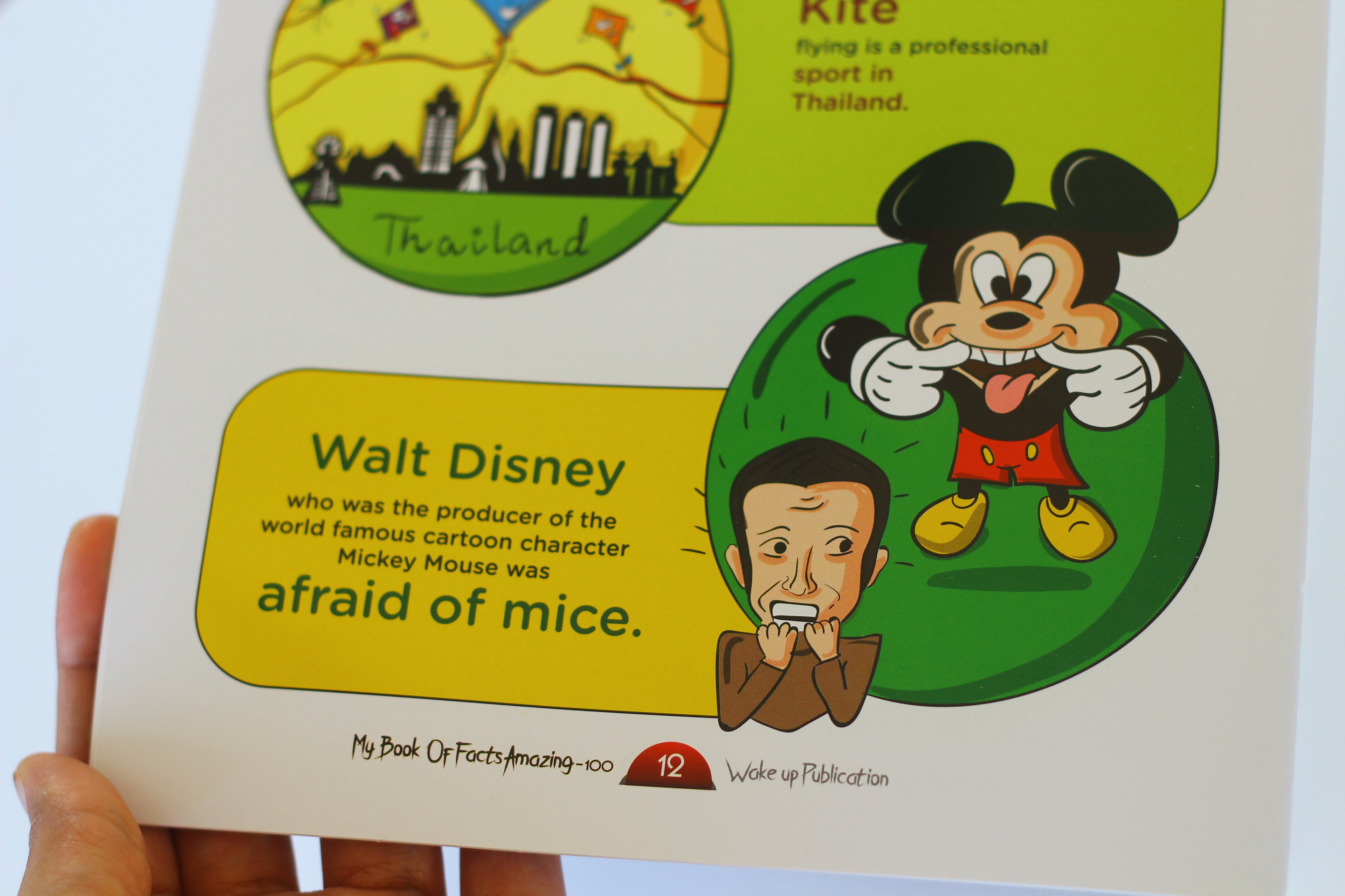 My Book of Facts, 100 amazing facts, pen to press: printed Walt Disney fact page held in hand