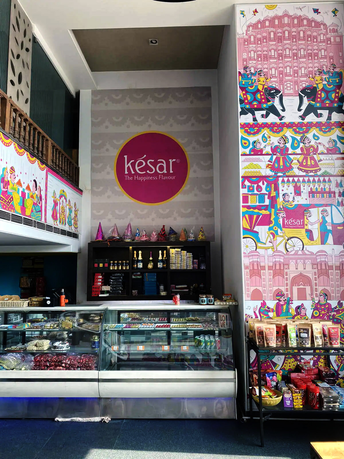 Kesar sweet shop space branding in Phad painting style: store interior with the Kesar wall art