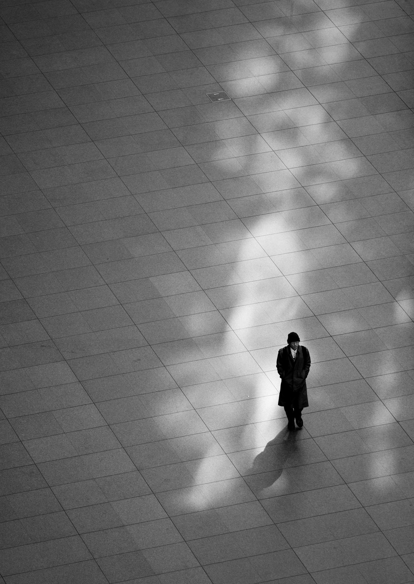 Lone man walking through the Tokyo International Forum building
