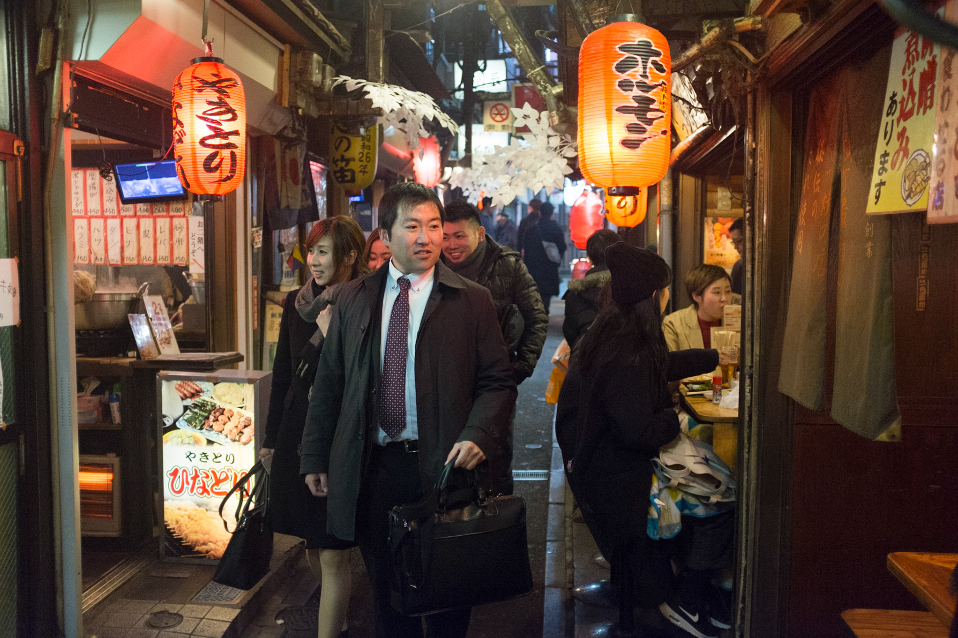 Friends checking out the various Izakaya pubs in Piss Alley, aka Omoide Yokocho or Shomben Yokocho