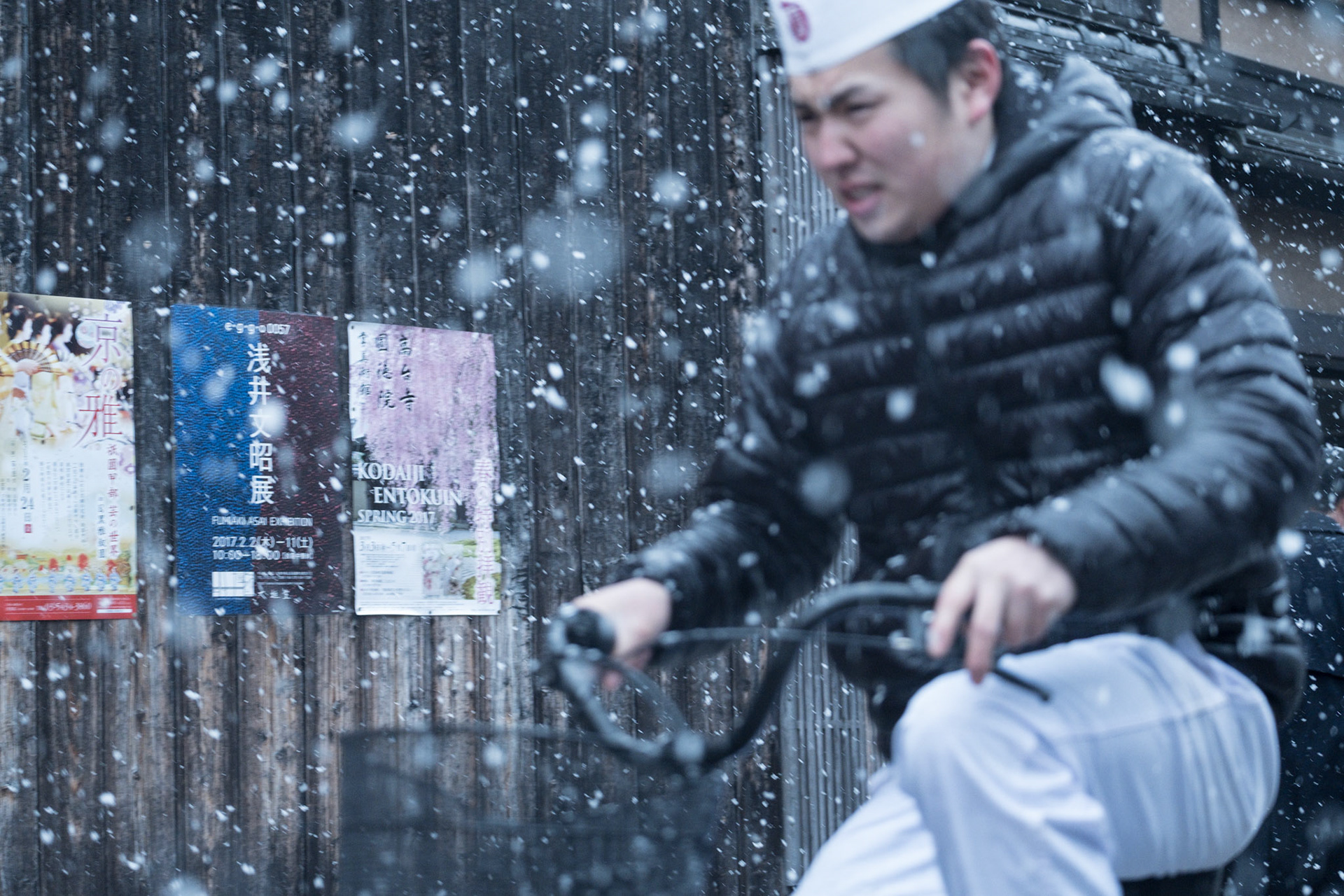 Delivery man to the famous Ichirikitei tea house battles the driving snow as he cycles back to his work.