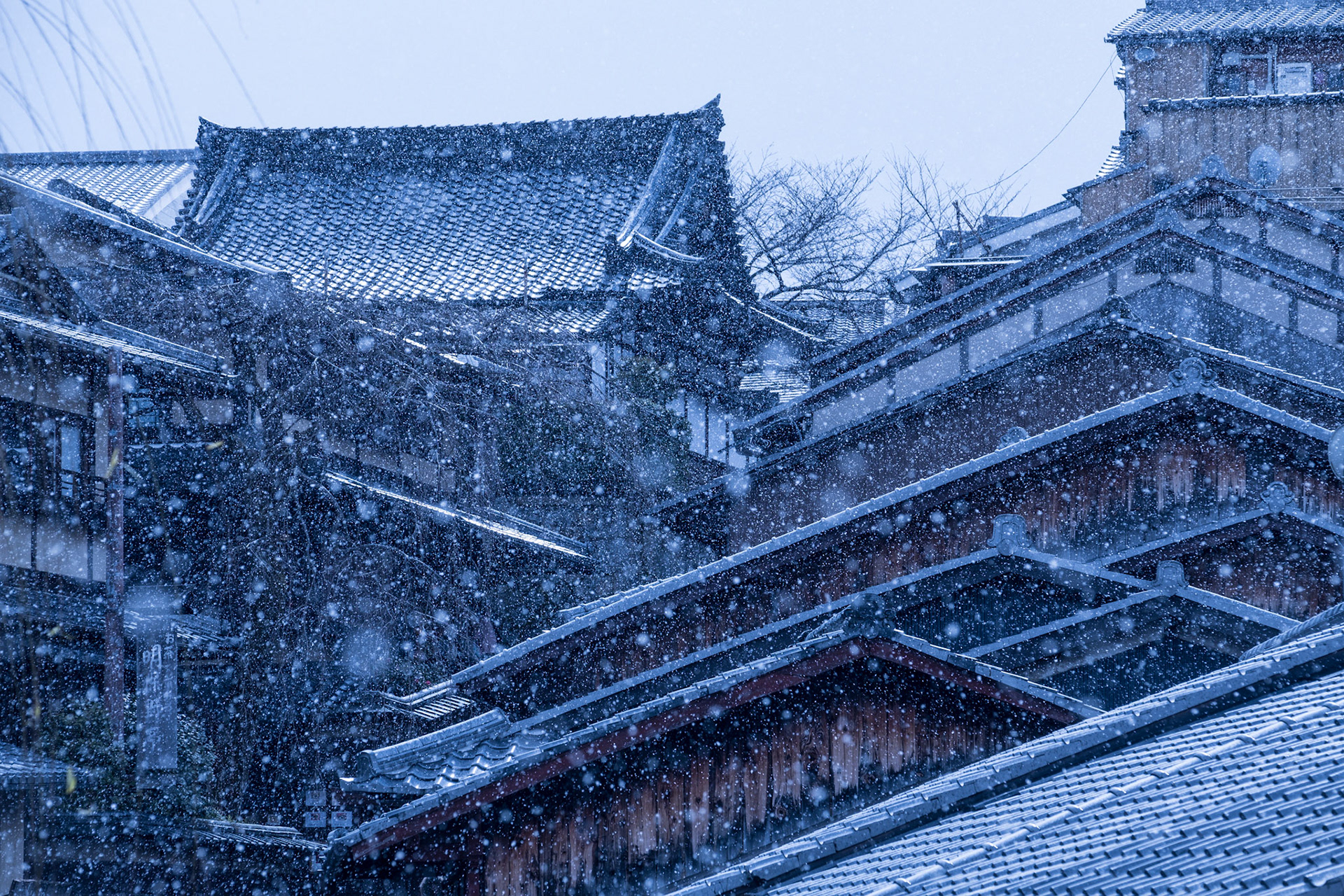 Traditional houses and shop rooflines during a snow shower in the ninenzaka and sannenzaka area of Higashiyama, Kyoto.