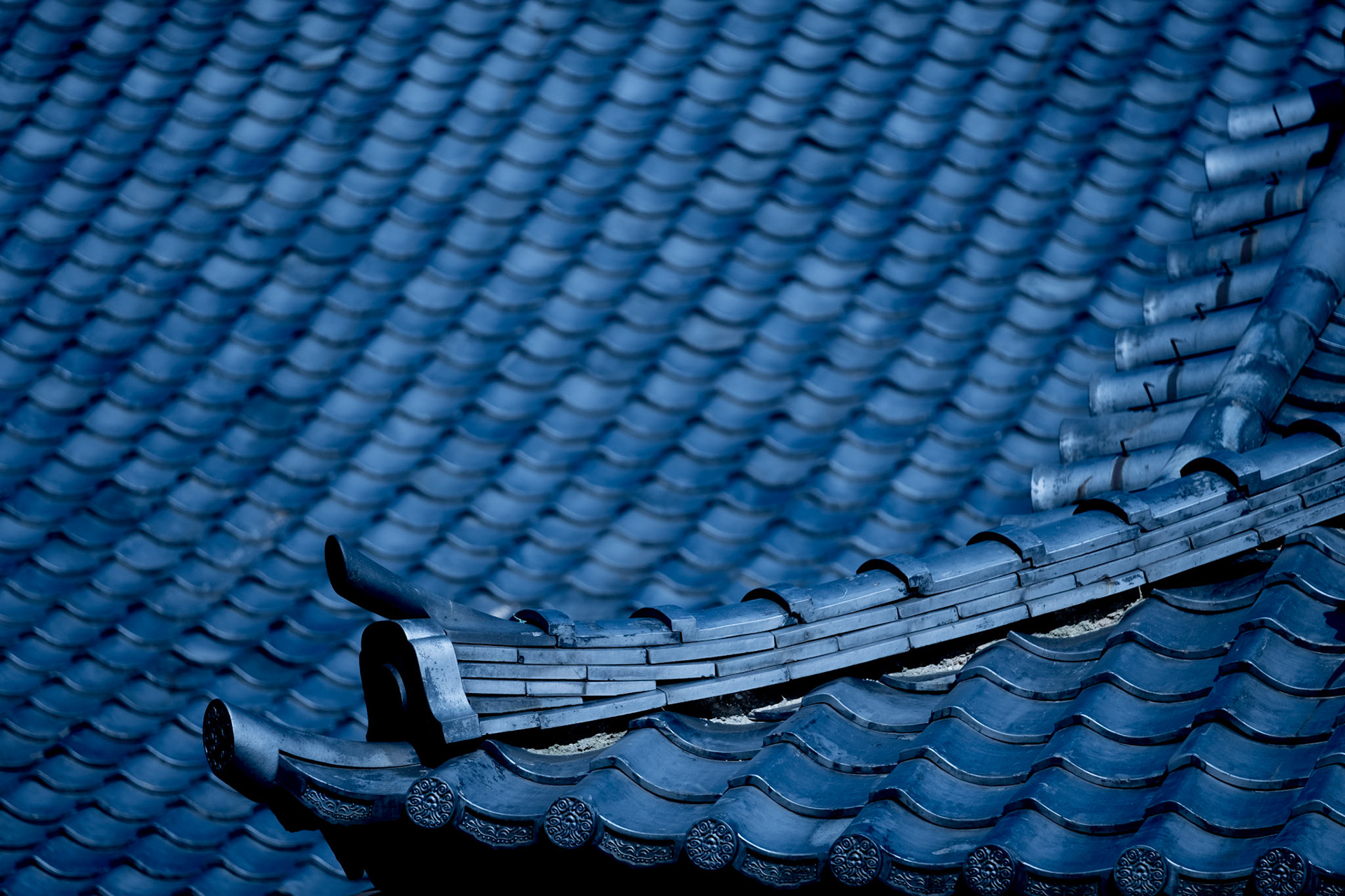 Traditional Japanese roof design with curved tiles.