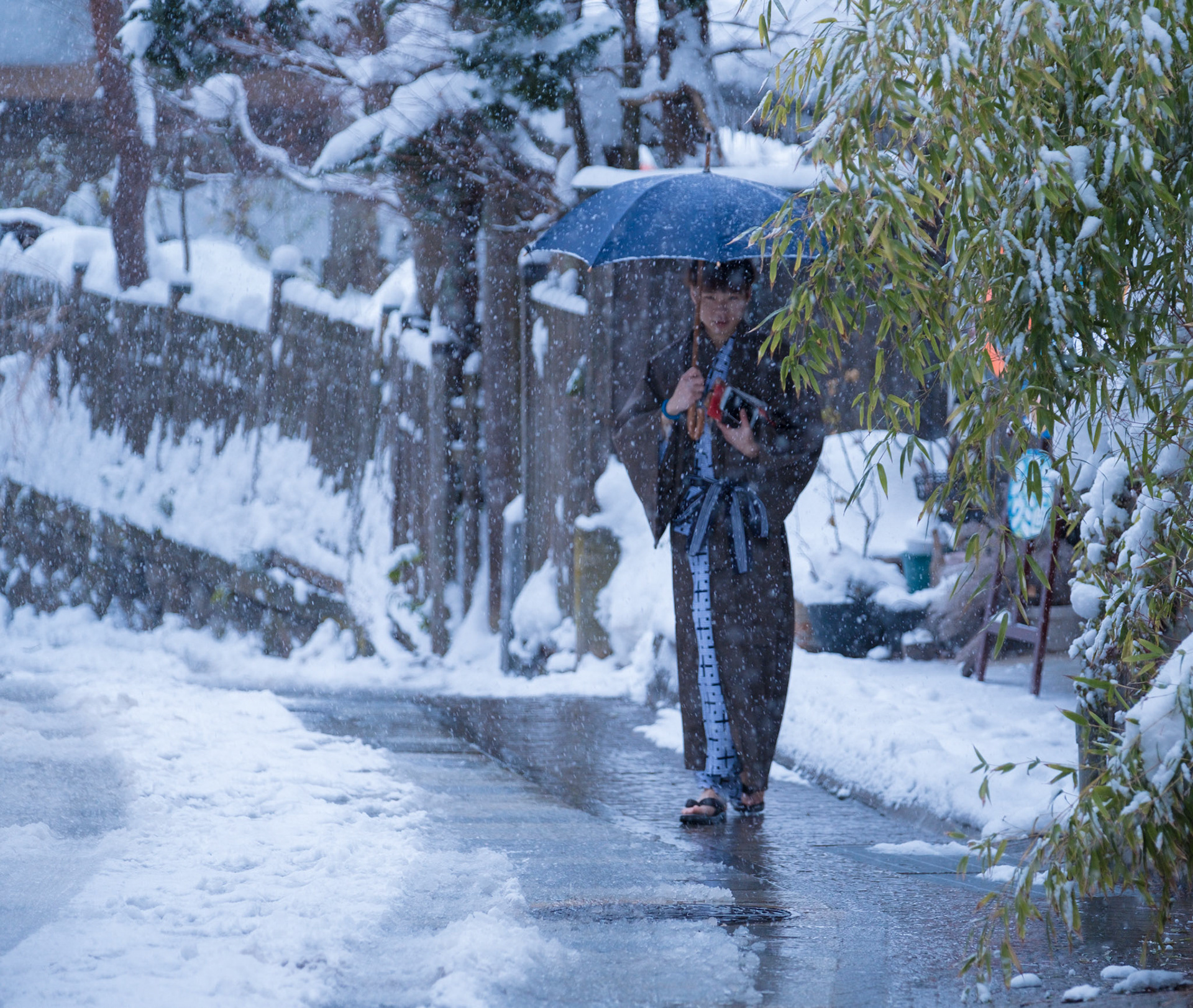 Man walking to a natural hotspring bath in the mountain village of Shibu Onsen.