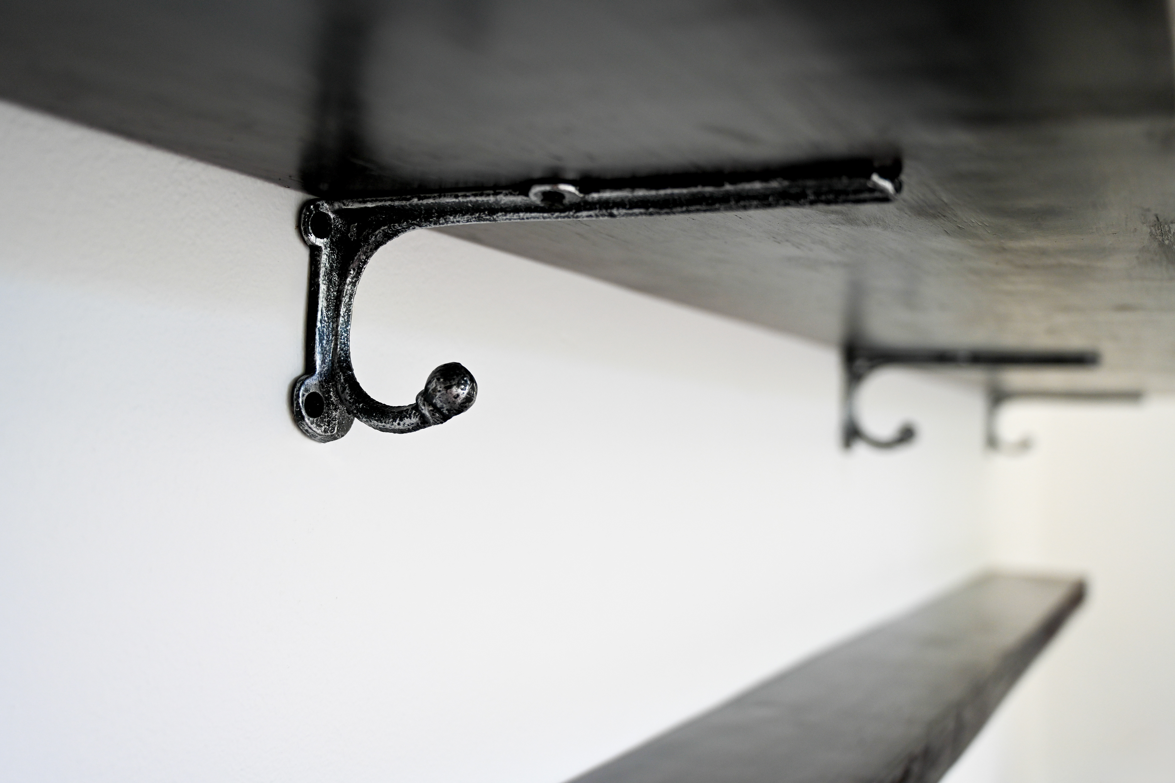 Dark wood shelving with iron brackets installed in the Master Suite kitchen at Hacienda Eterna Primavera. The rustic design enhances the hacienda-style charm, adding warmth and character to the fully equipped Airbnb kitchen.