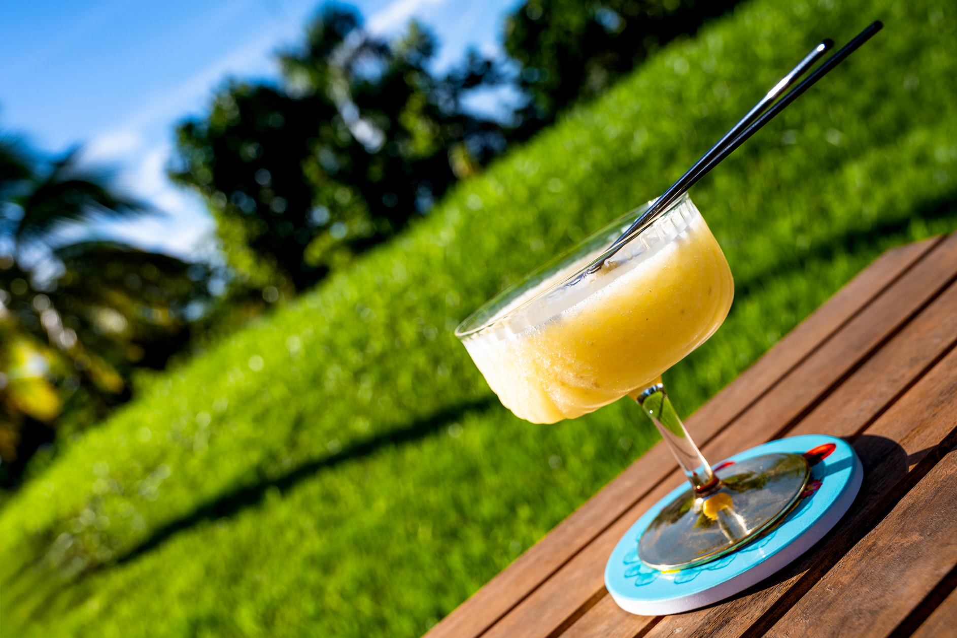 A refreshing banana daiquiri set against a lush tropical backdrop at Hacienda Eterna Primavera, capturing the essence of relaxation and island living in Puerto Rico.