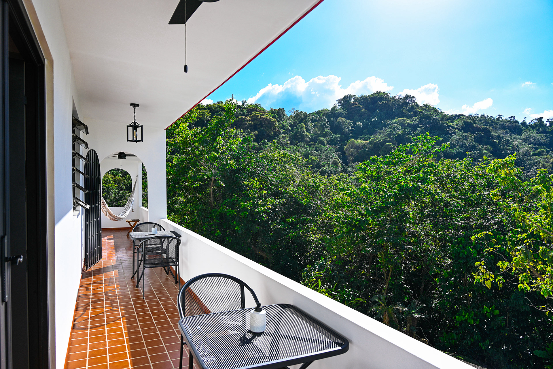 The newly furnished West balcony at Hacienda Eterna Primavera offers a breathtaking view over the tropical mountains. This long, spacious balcony is the perfect spot to relax with a cup of coffee in the afternoon sun or enjoy a handcrafted cocktail while watching the sunset.