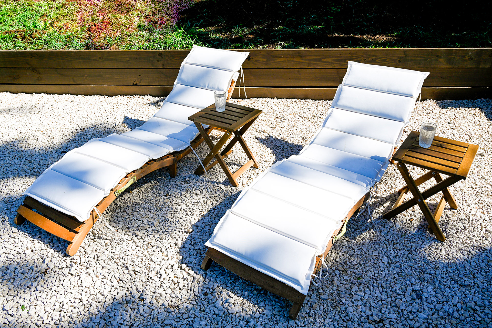 Outdoor lounge chairs set in the private tropical garden of Hacienda Eterna Primavera's Master Suite, surrounded by lush greenery.