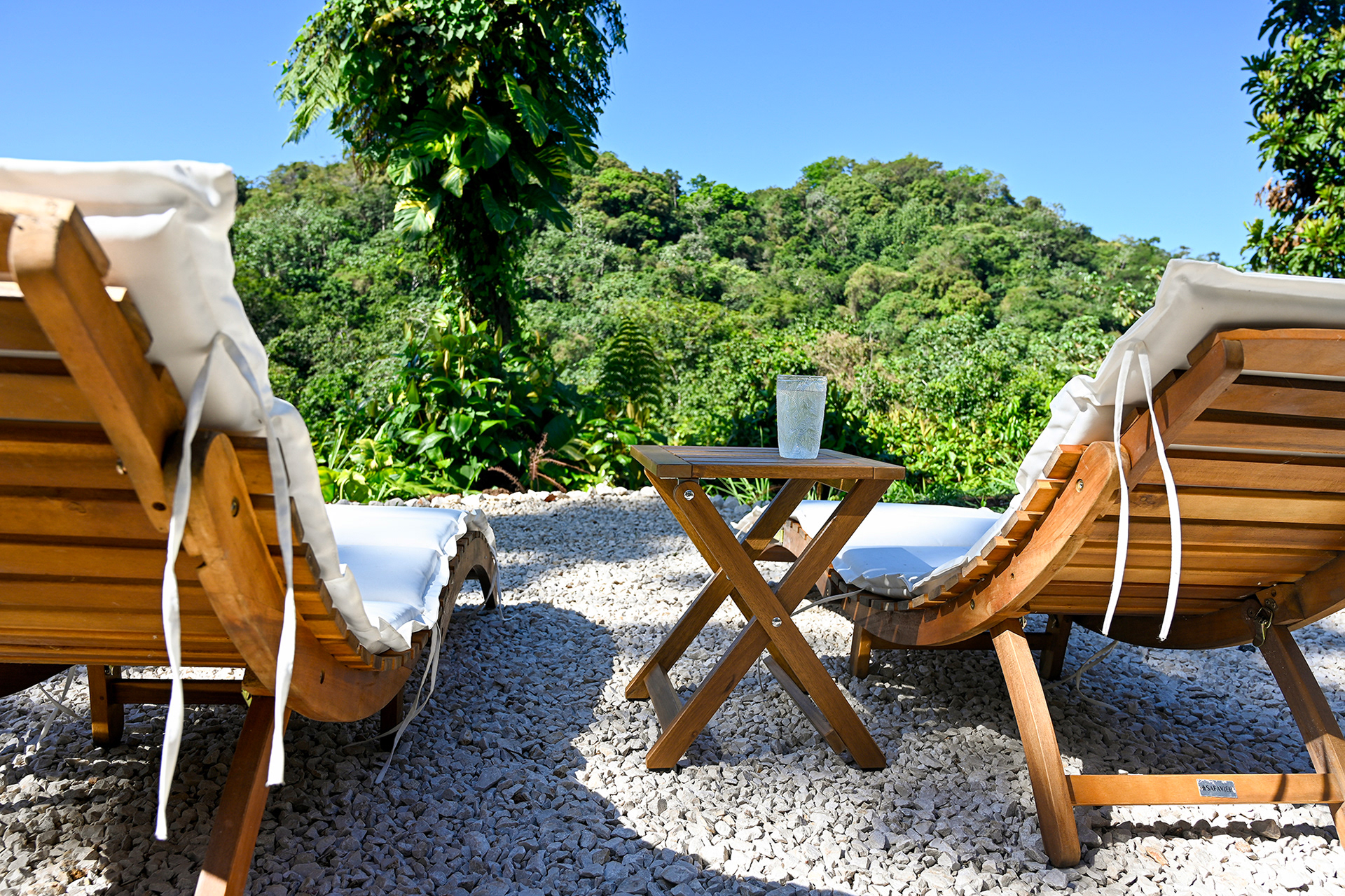 Unwind in your private garden with lounge chairs and mountain views — the perfect place to relax under the tropical sky