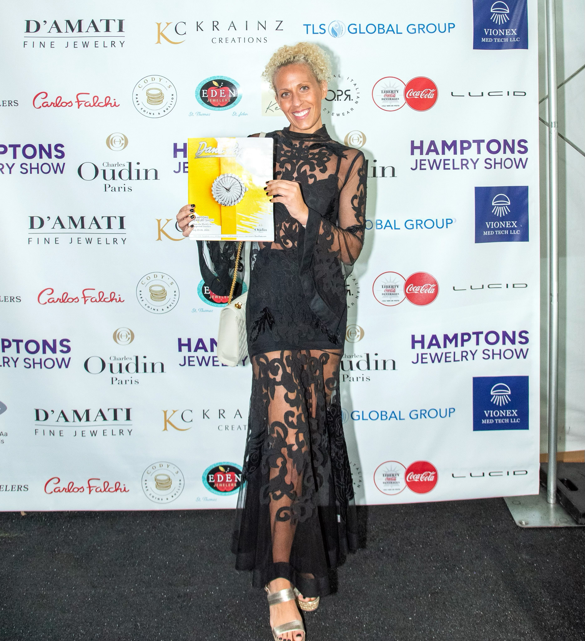 Holding up the recent issue of Dan's Papers at The Hamptons Jewelry Show