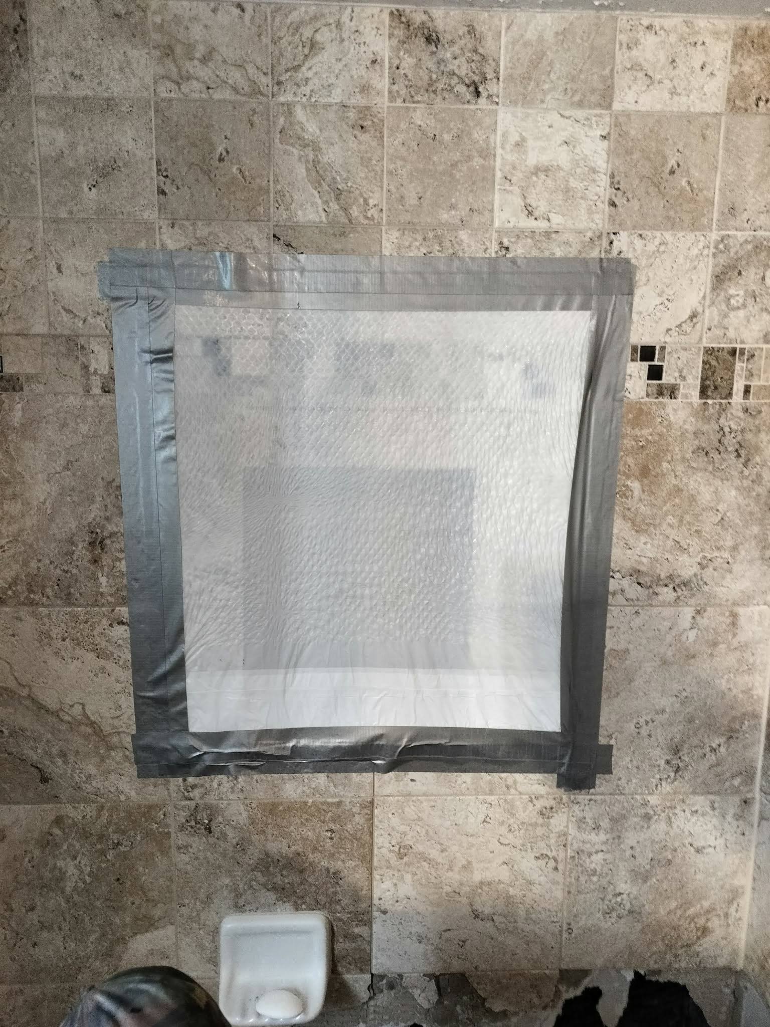 Showering with a garbage bag due to leak in it.