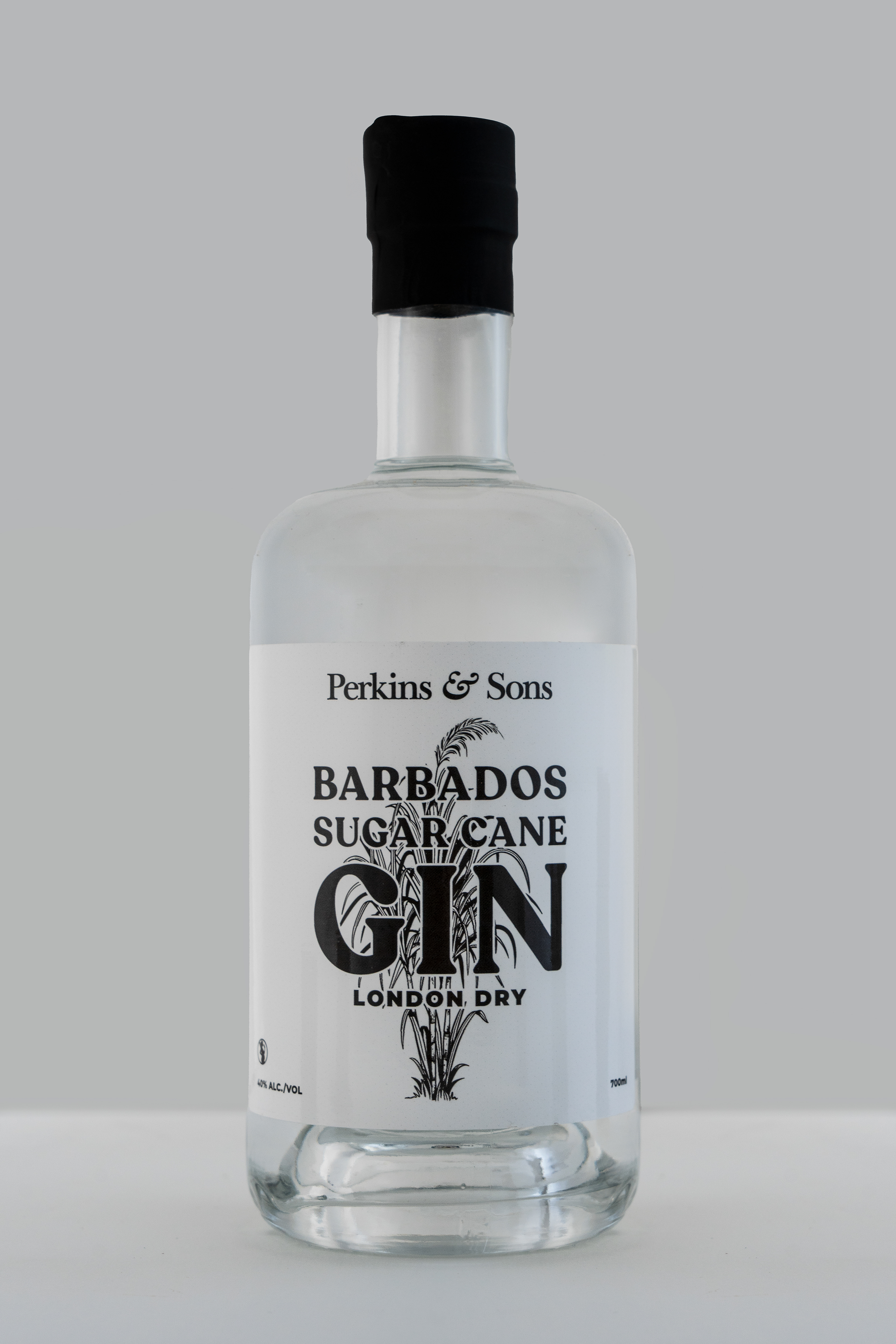 Perkins & Sons Barbados Sugar Cane Gin, London Dry, clear bottle product shot on grey background