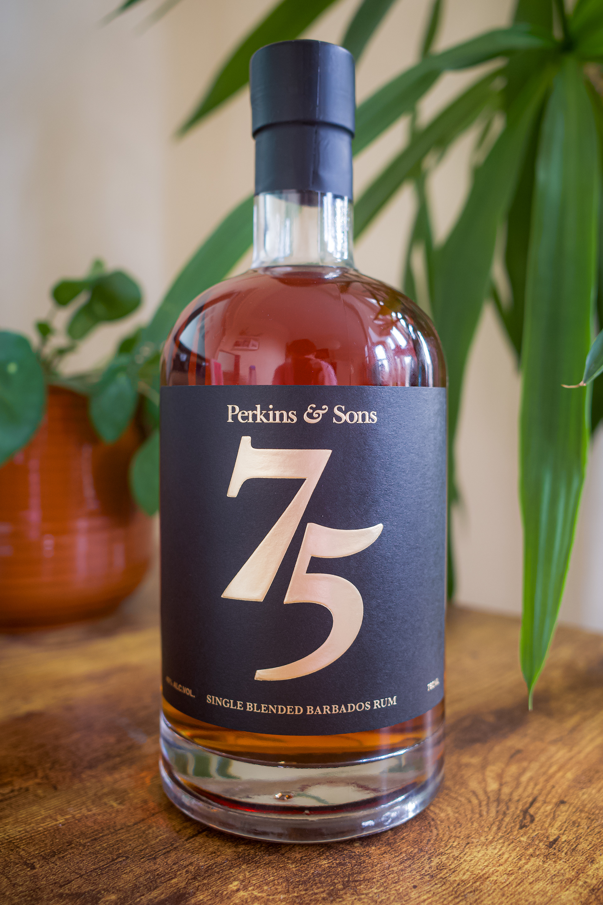 Perkins & Sons 75th Anniversary 12-Year Rum, black label with gold foil lettering