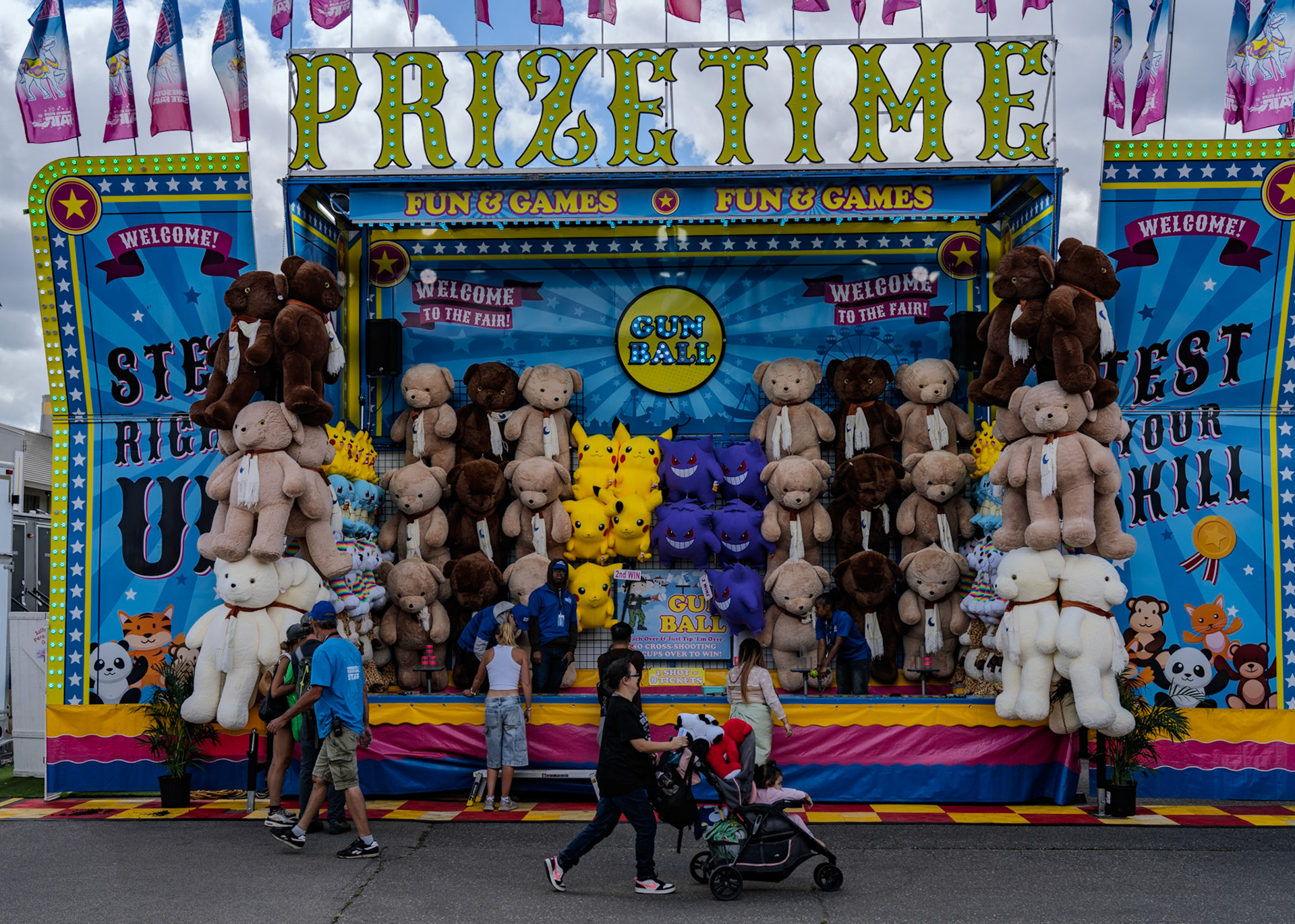Prizes hang as contestants step up on the midway at the Minnesota State Fair