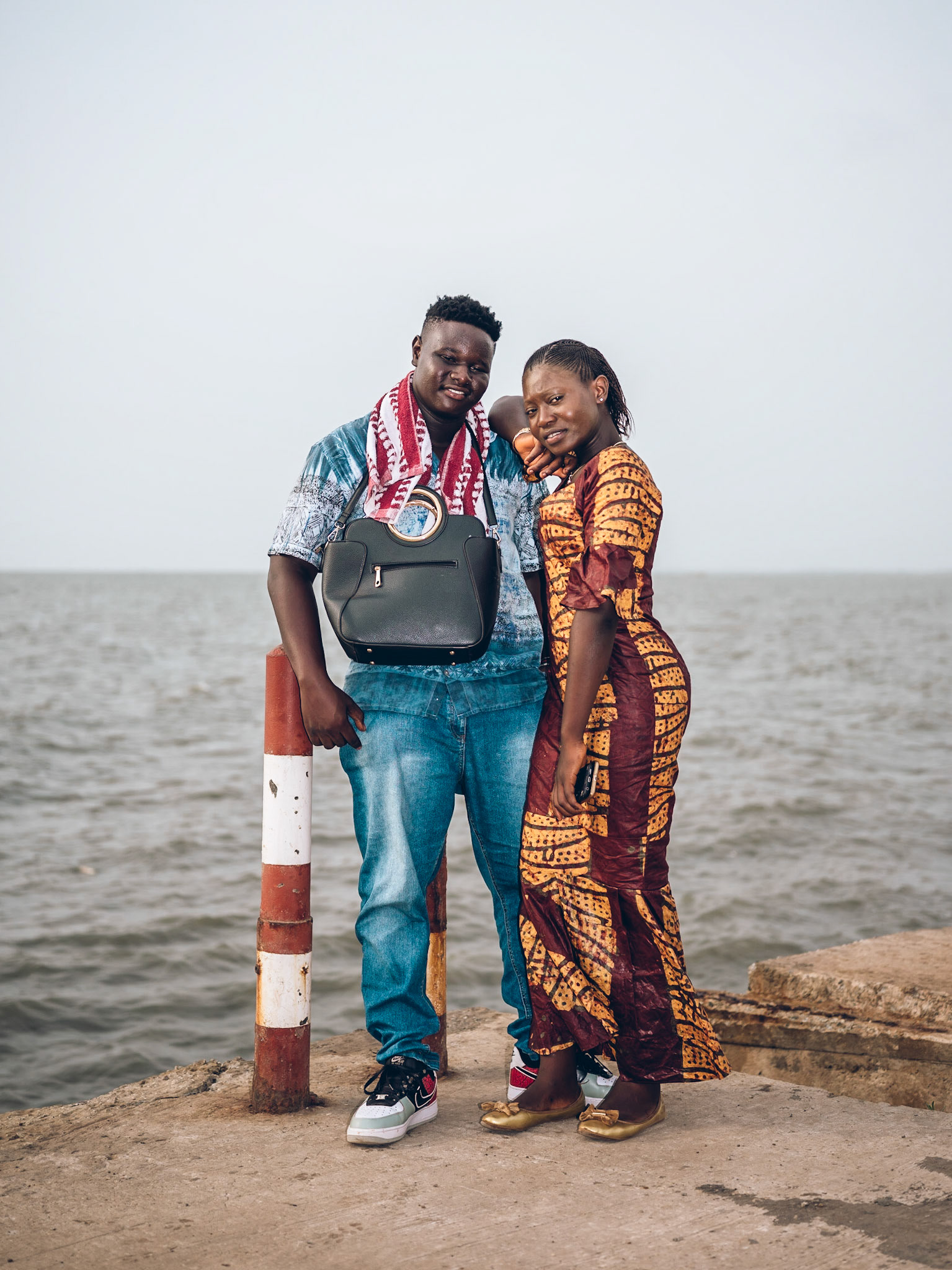Elhadj Bangaly Diallo (L) and Mamaissta Bangoura (R) enjoy an outing by the sea in Centre Emetteur in Kipe. Conakry, Guinea.