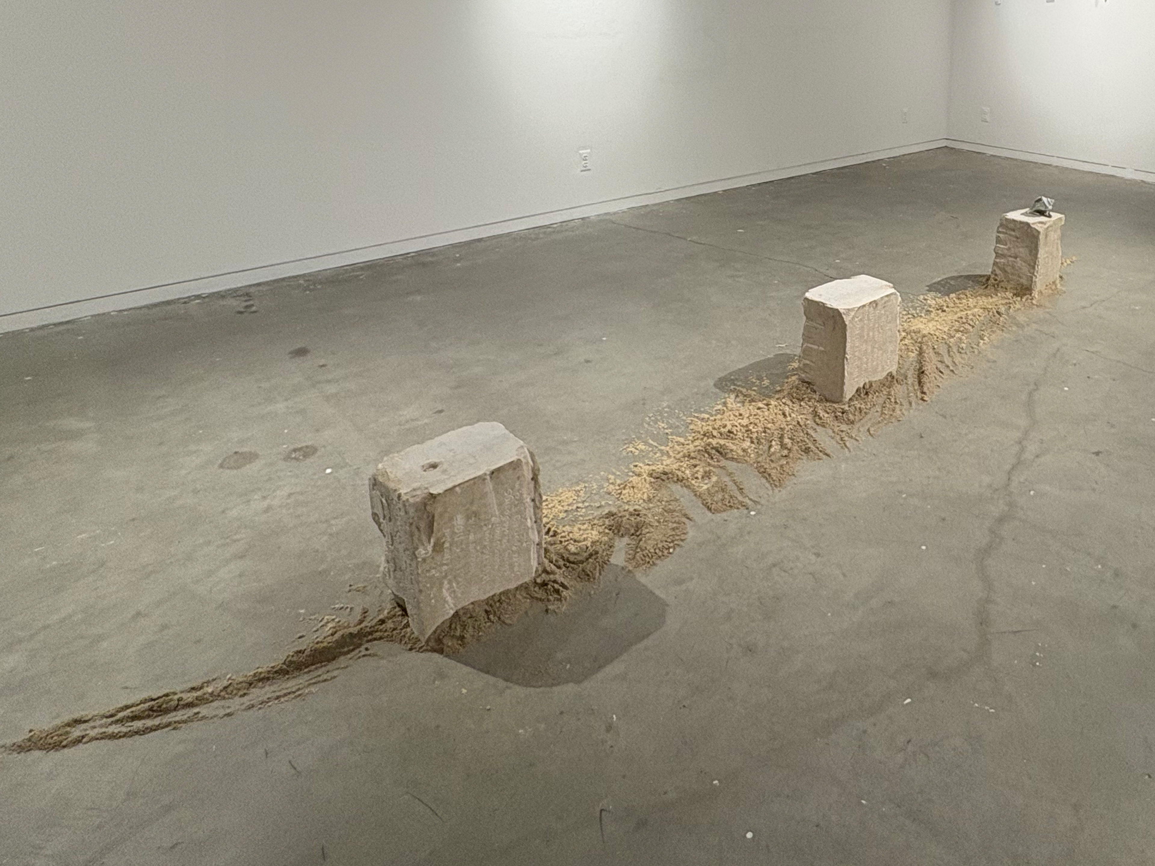 Shawn Sweeney, VIA, 2026. Large-scale sculpture using limestone architectural fragments from the Cincinnati Art Museum and sand from Rockaway Beach, 96x30x16 inches. Contemporary sculpture exploring grief, memory, and displacement.
