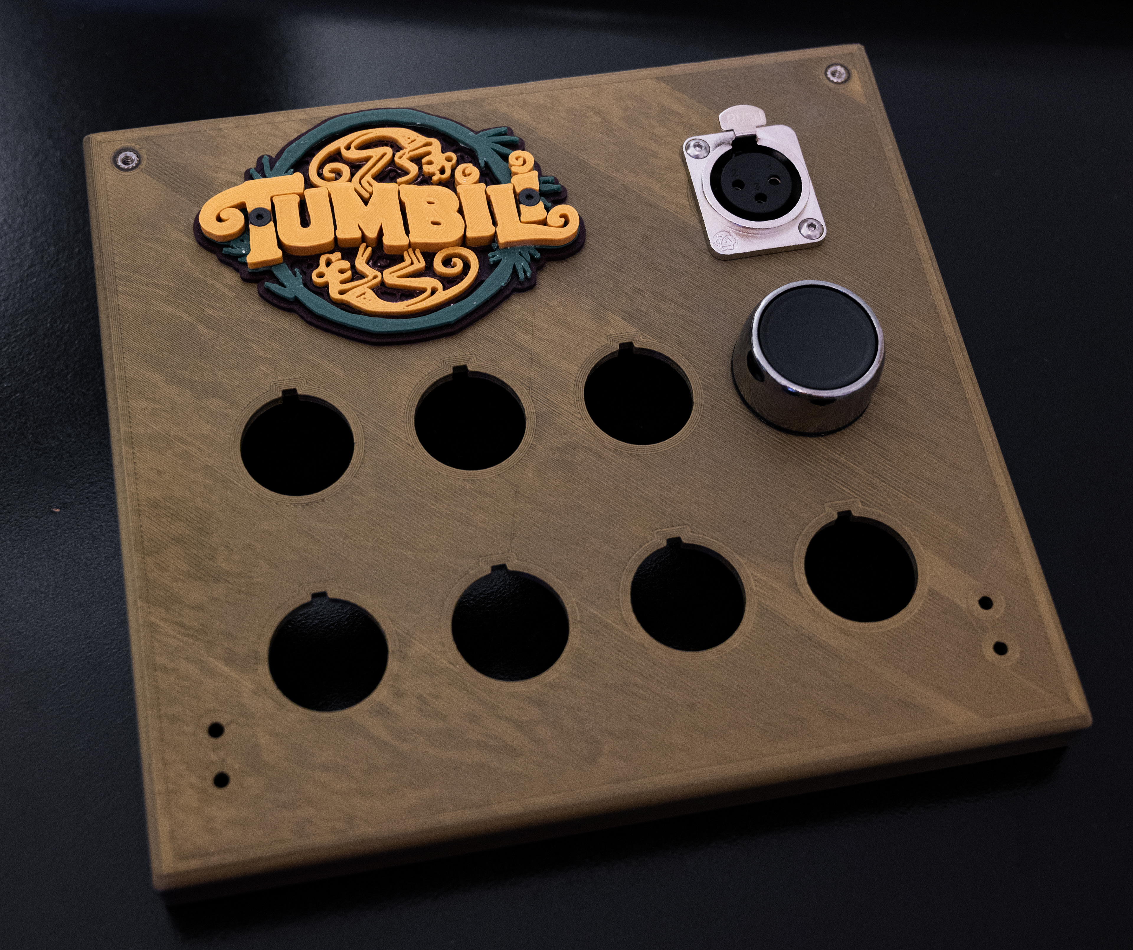 The full size panel plate with the Tumbili logo model, XLR jack, and a 22mm push button, before application of the vinyl sticker graphic.