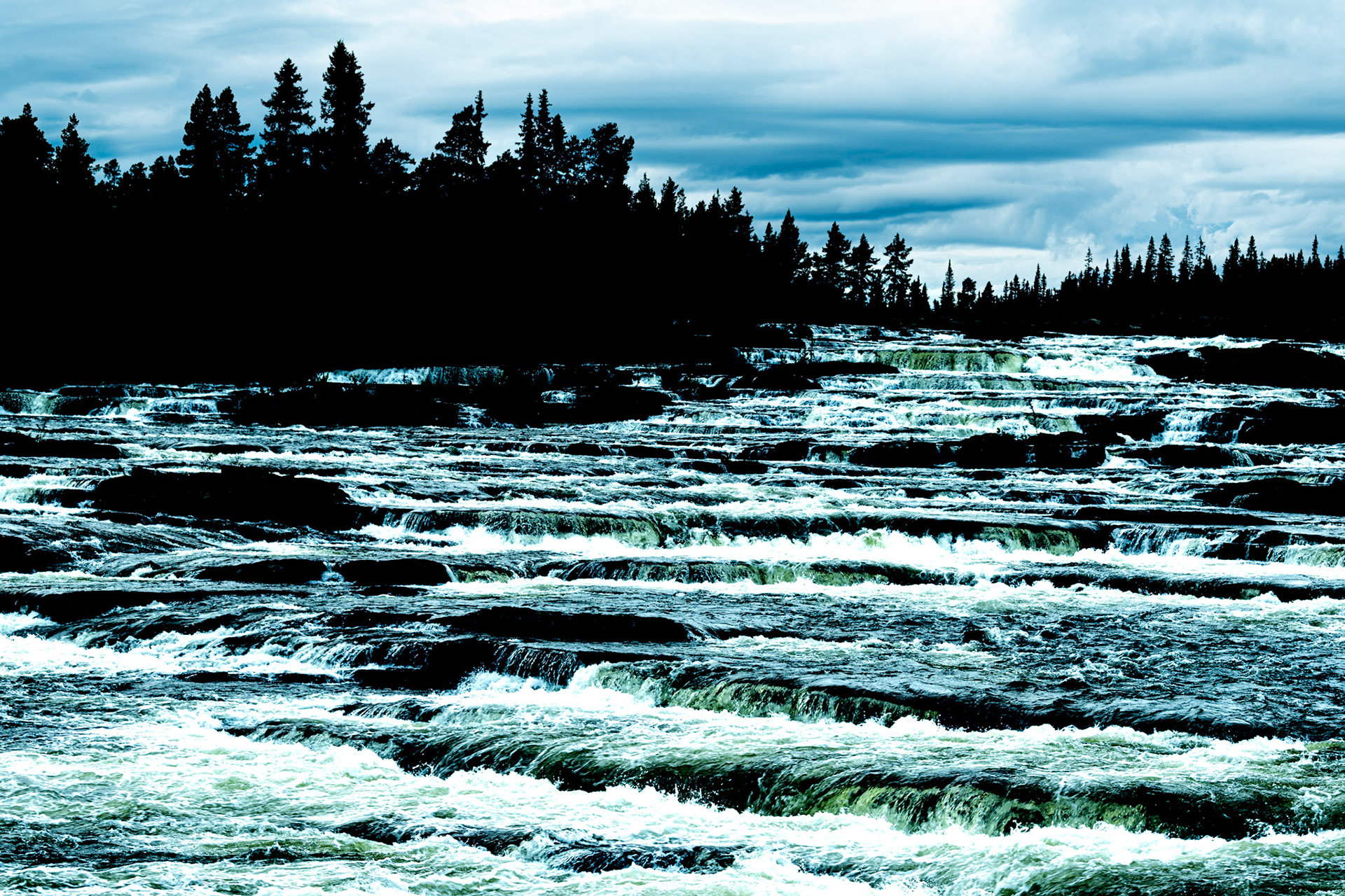 Trappstegforsen means stairs of waterfalls. The waterfall has several small cascades. You can se Trappstegsforsen on the road between Saxnäs and Vilhelmina in Sweden.
