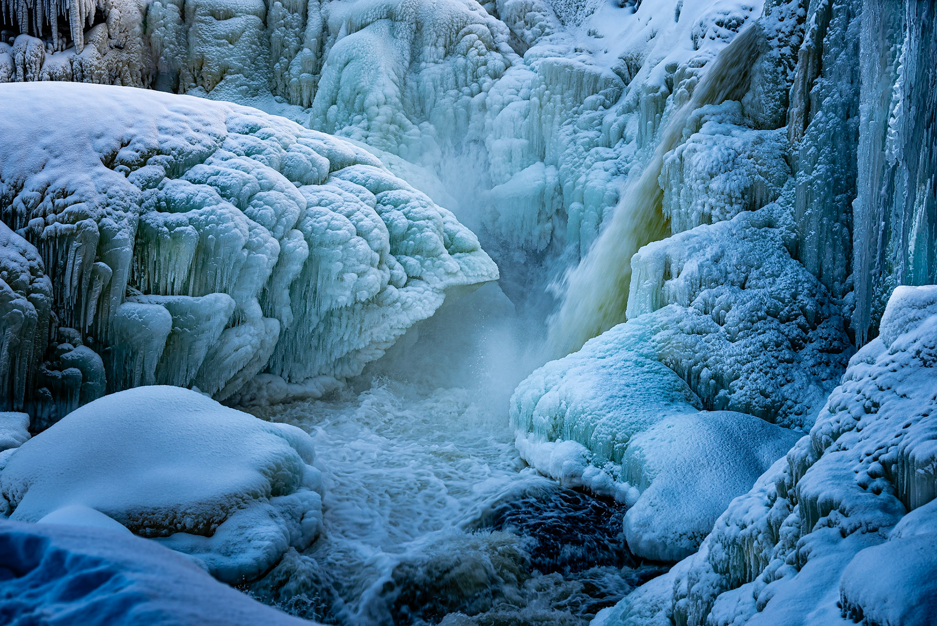 Waterfall Ristafallet in Sweden in winter with large amounts of ice, snow and icicles. Ristafallet is a powerful waterfall near Åre in the region Jamtland. It was a cold day in January 2025.