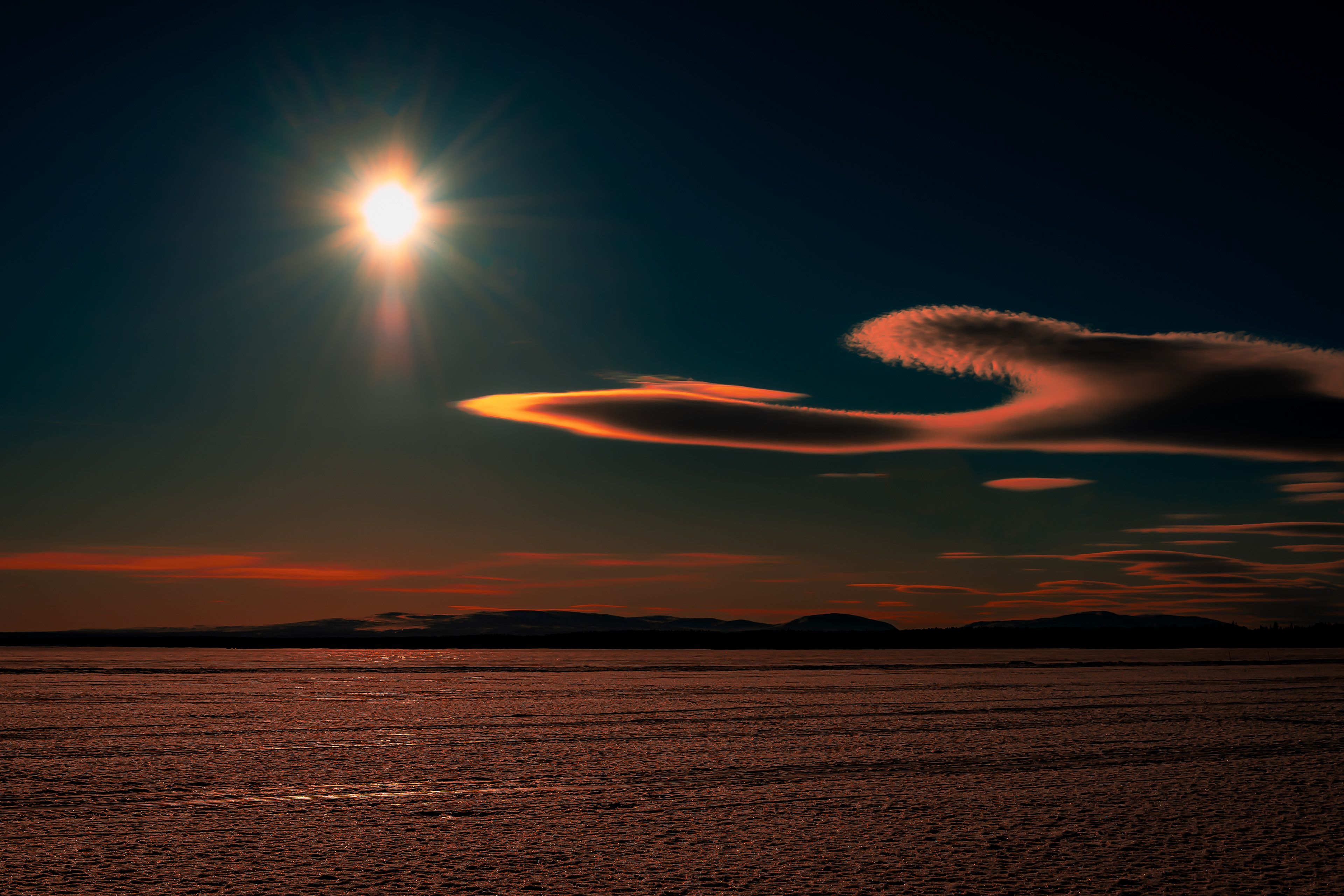 Cloud with unusual appearance a winter day with ice on a lake in Sweden