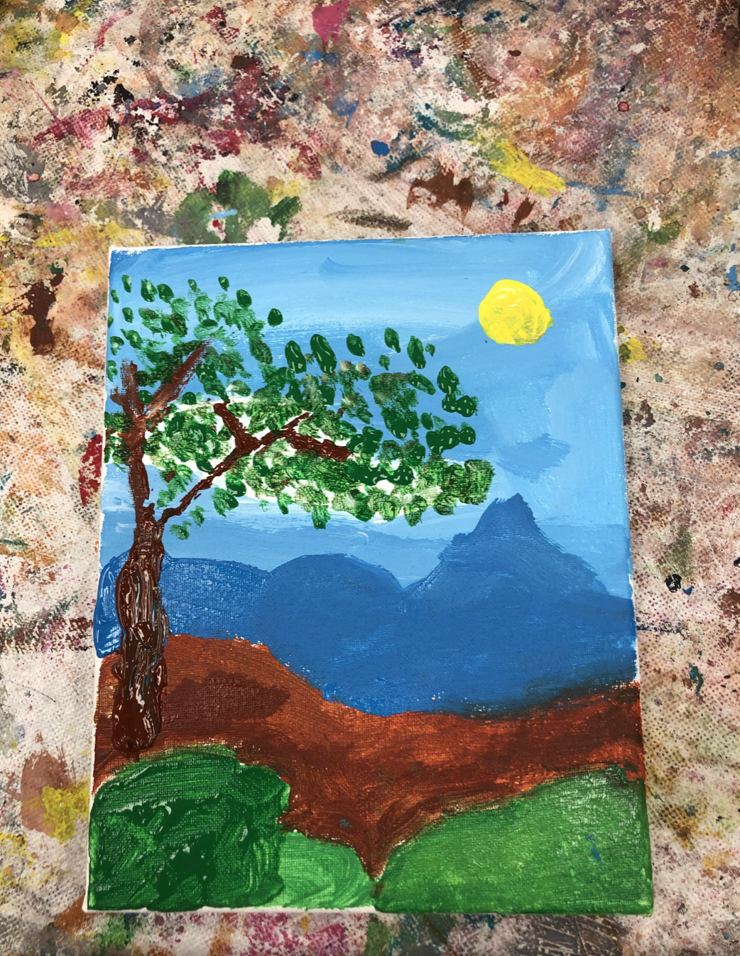 Stippled leaves on this 2nd grader's landscape painting!