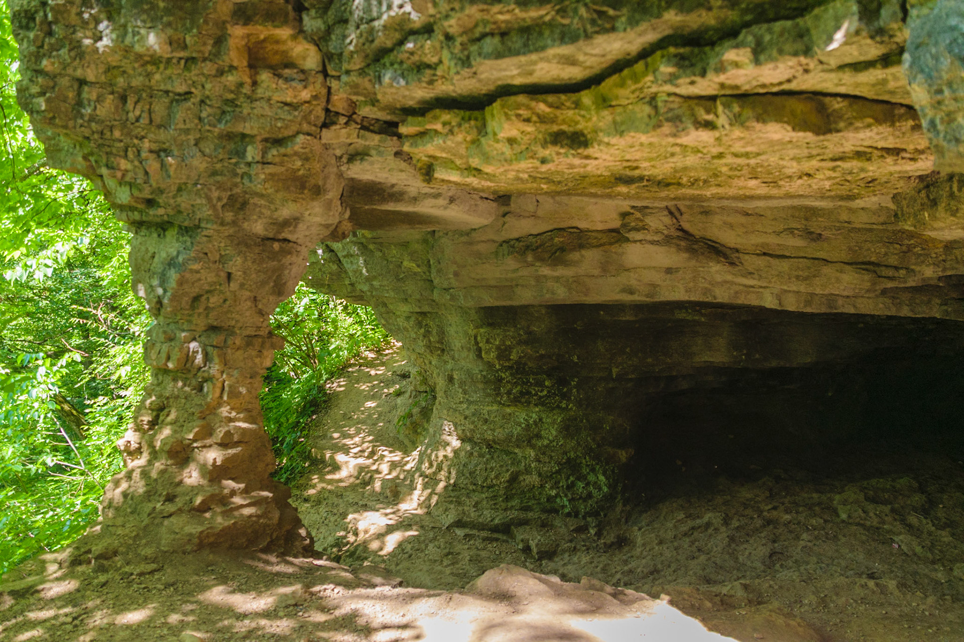 A small cave awaits anyone brave enough to travel up the trail. It appears the only thing preventing its collapse is a thin stone collumn.