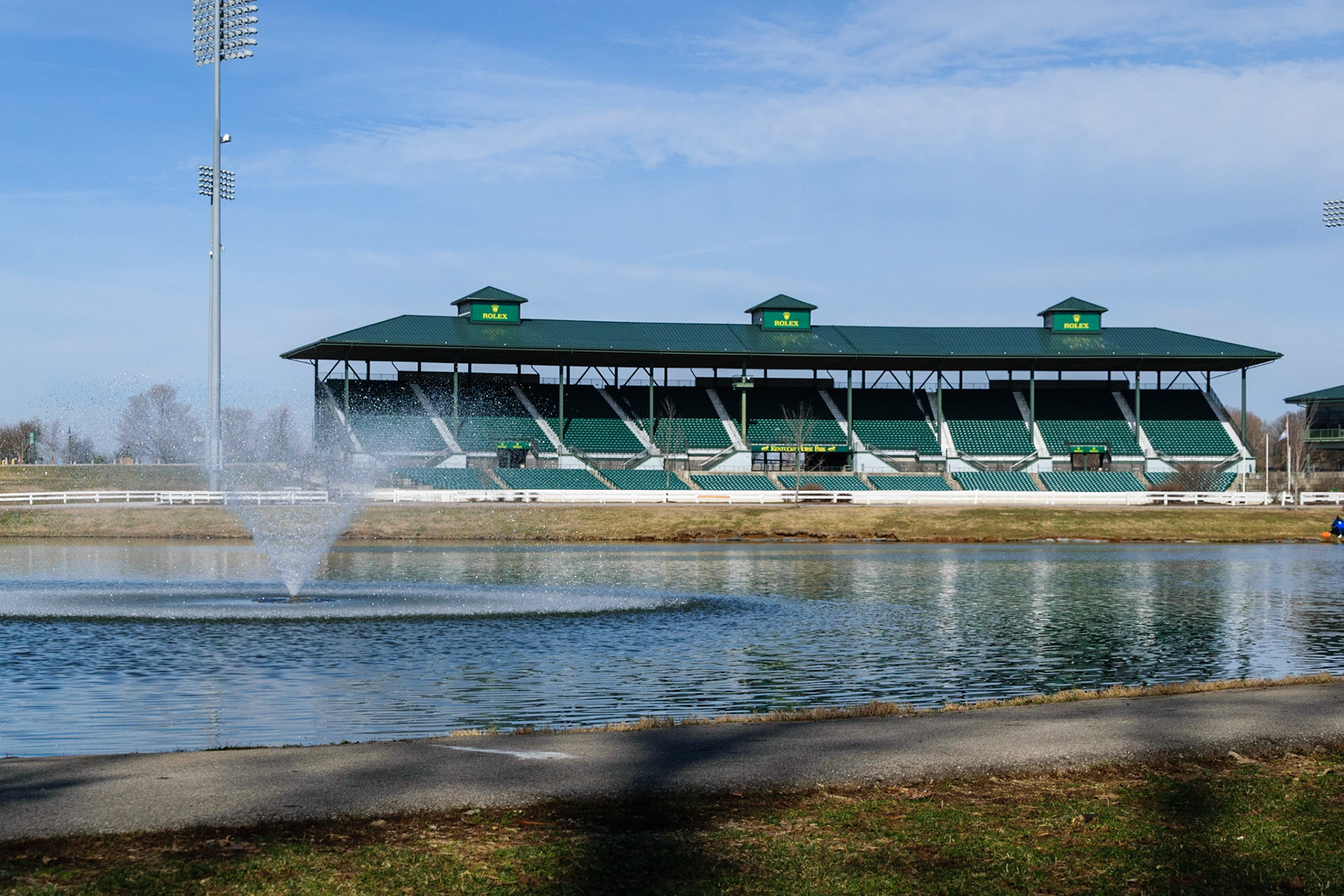 The stands of Rolex Arena loom over the large lake.